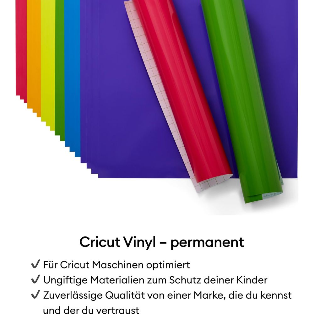 Mehrere Rollen Vinyl in Regenbogenfarben, Rot und Grün auf lila Unterlage.