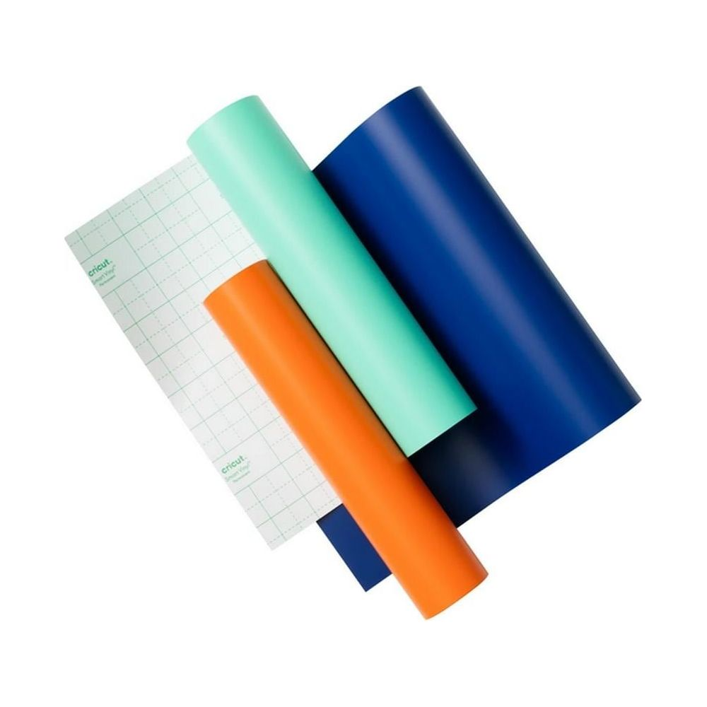 Rollen aus Transferband, orange, mint und dunkelblau liegen auf weißem Hintergrund.
