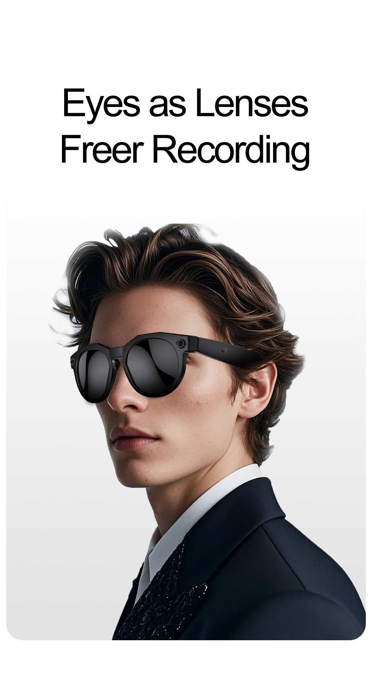 Ein Mann mit dunklen Haaren trägt eine schwarze Sonnenbrille und einen Anzug.