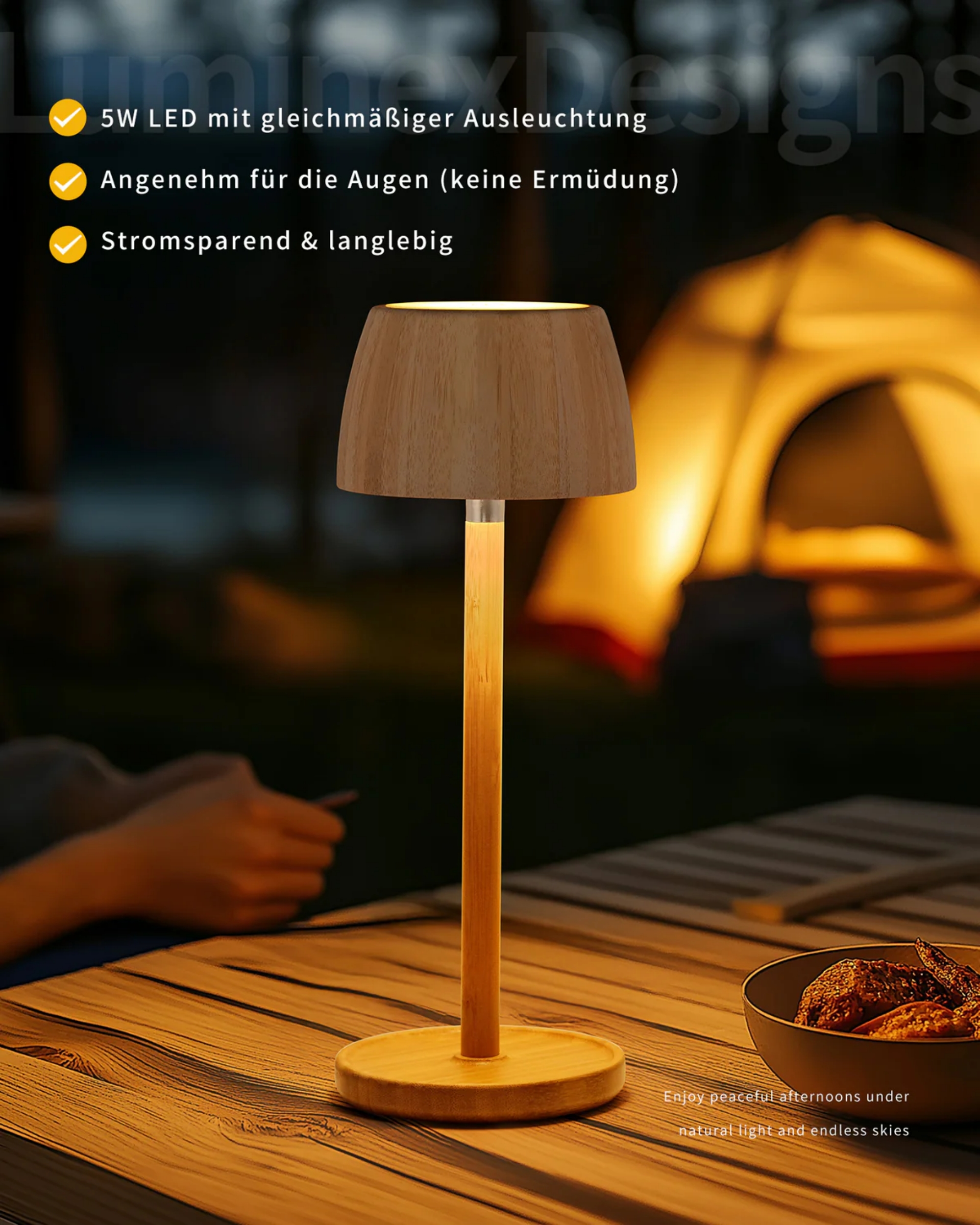 Eine Lampe mit Holzdetails steht auf einem Tisch, mit einem Zelt im Hintergrund.