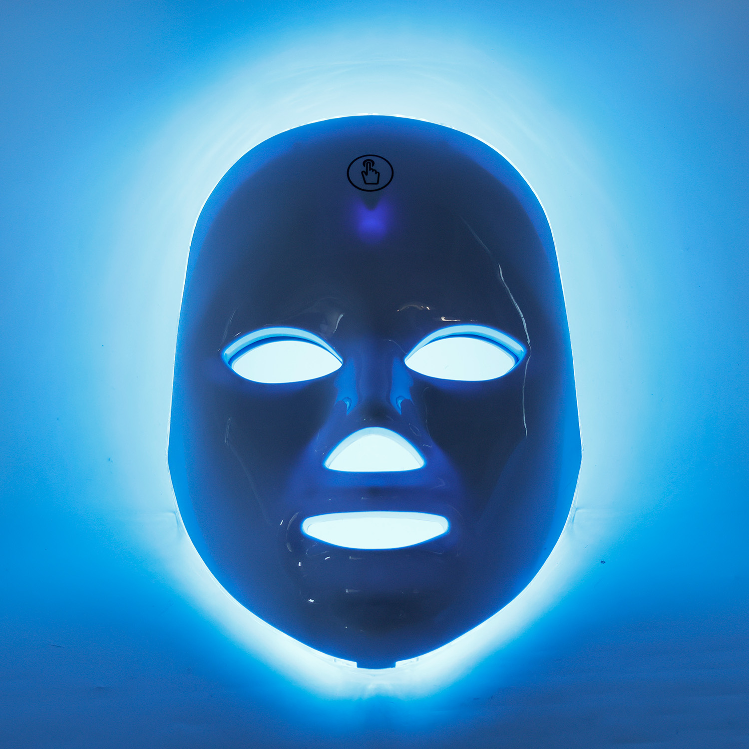 Niebieska maska ​​do twarzy LED świeci na jasnoniebieskim tle.