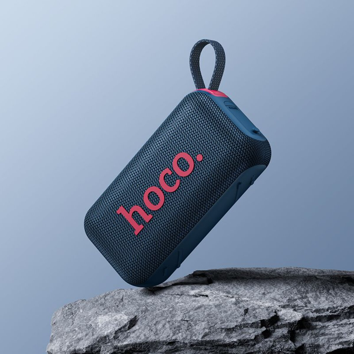 Un altoparlante blu con scritta rossa "hoco." su una roccia.