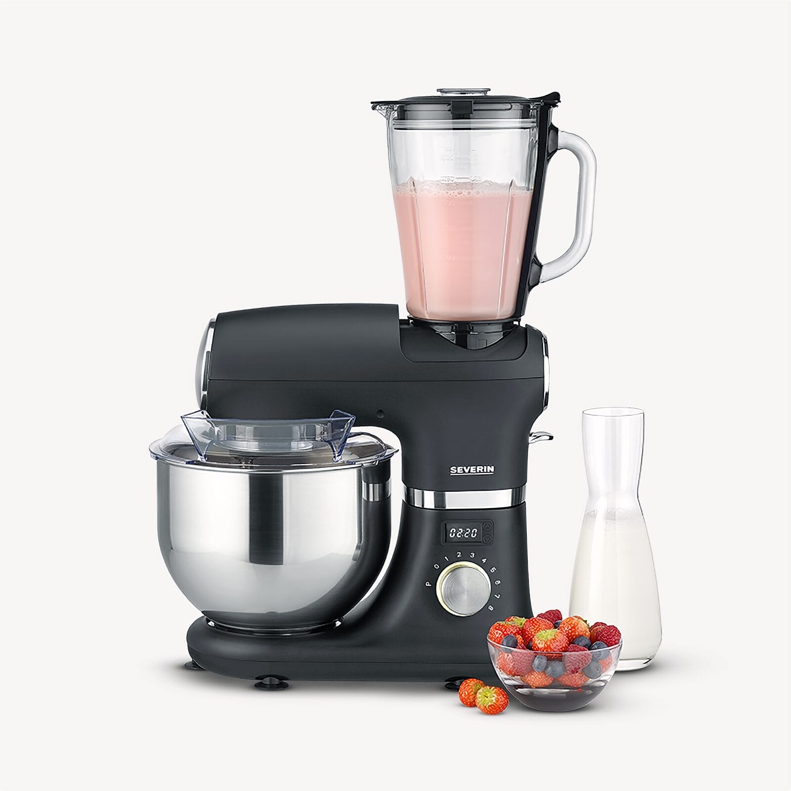 Black stand mixer with blender attachment, mixing bowl, berries, and milk jug.