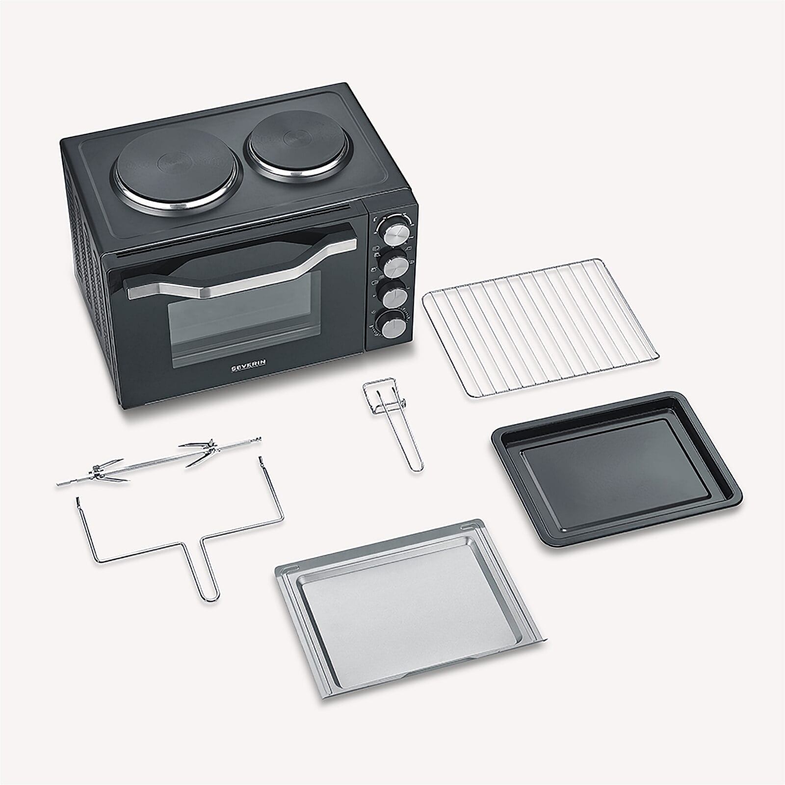 Four noir compact avec deux plaques chauffantes et accessoires: grille, plaque et tournebroche.