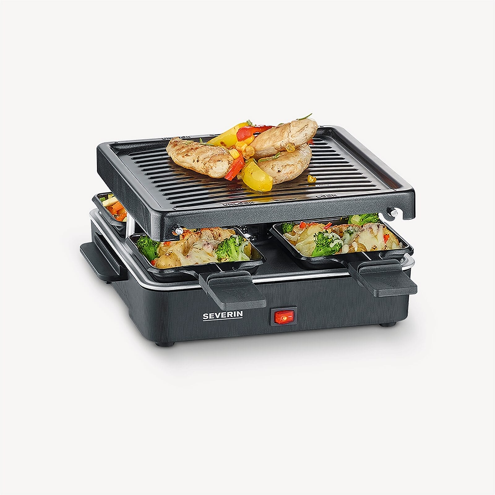 Ein Raclette-Grill mit Hähnchen, Gemüse und Kartoffeln