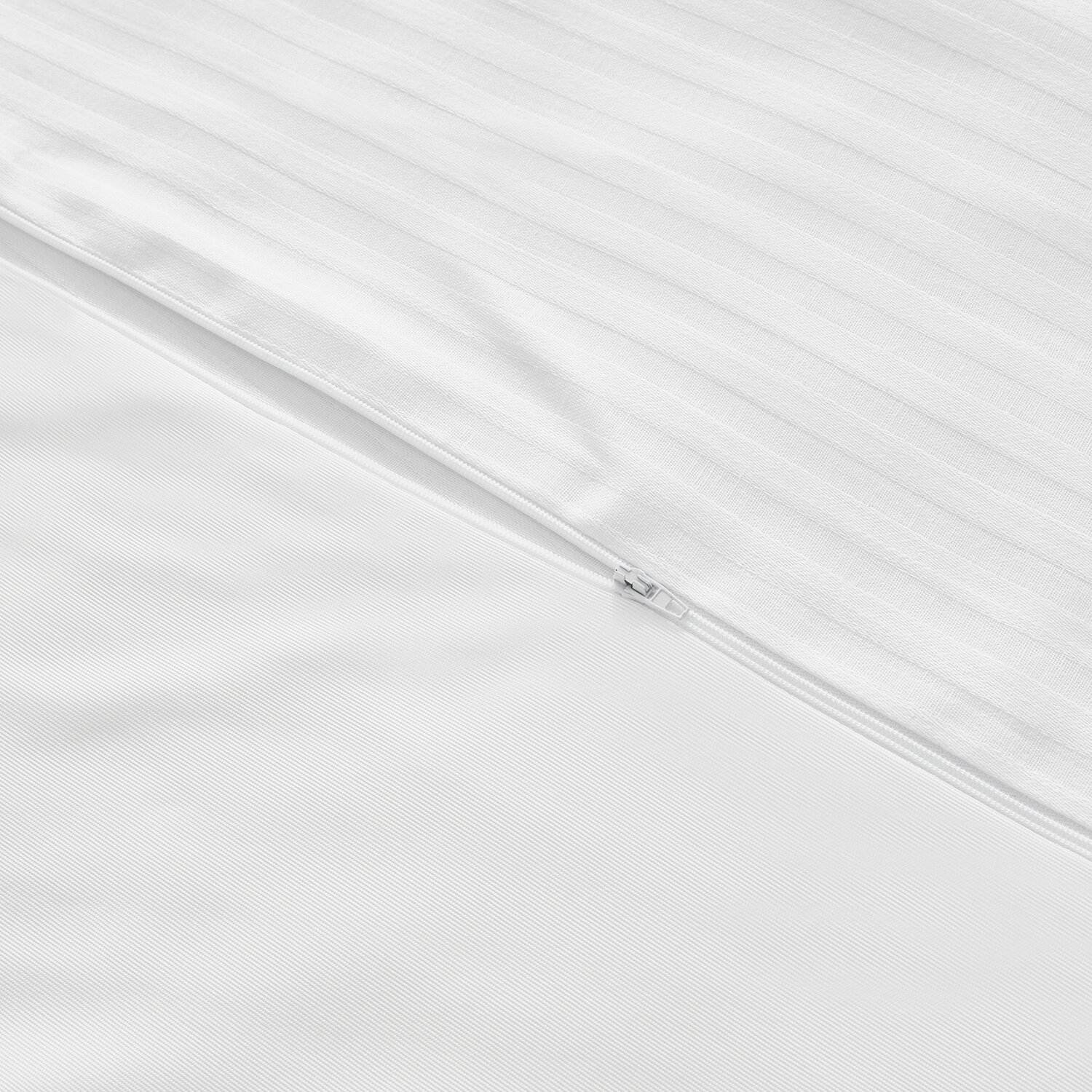 Primer plano de ropa de cama blanca con rayas verticales y una cremallera.