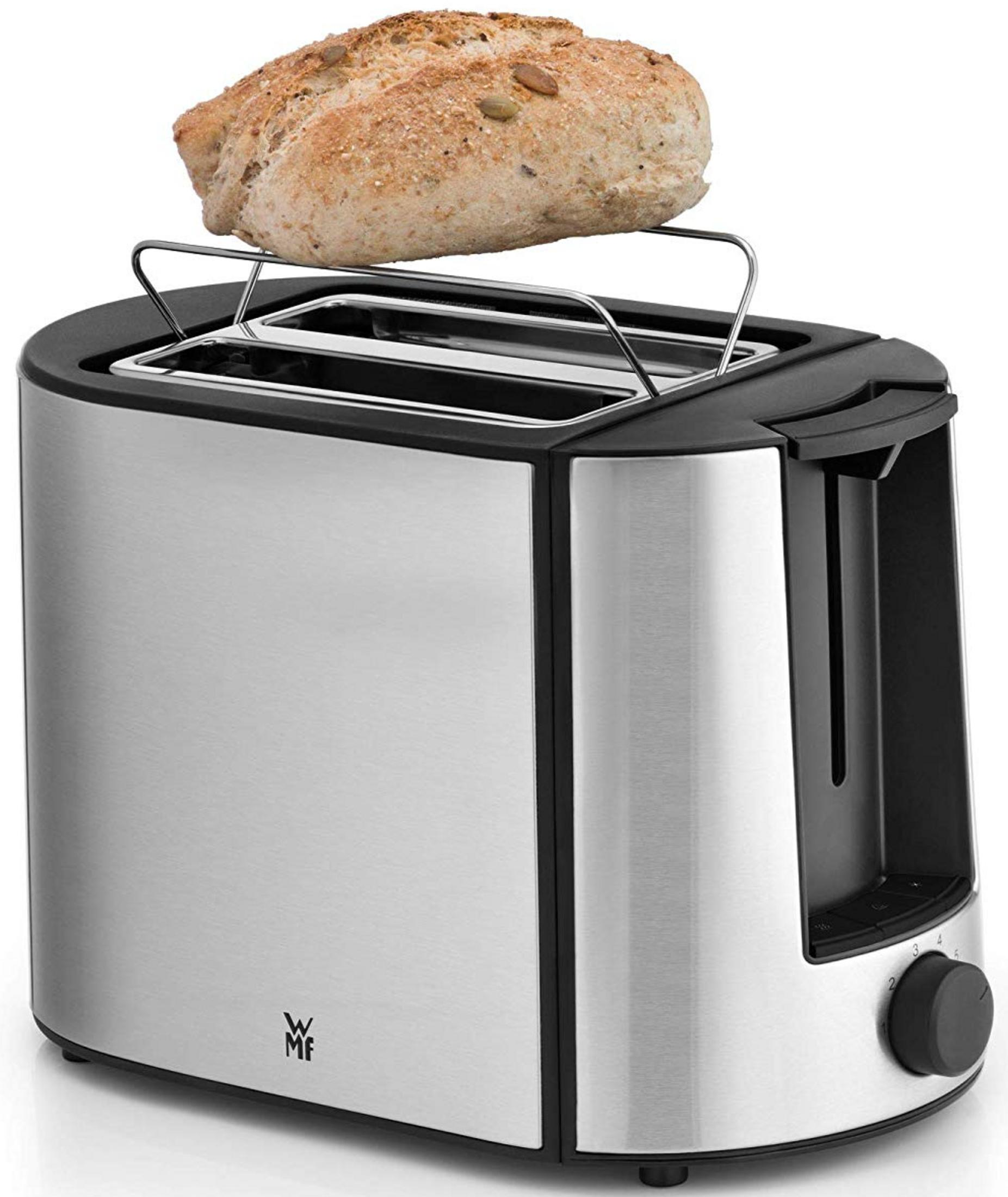 Srebrny toster z chlebem na podgrzewaczu.
