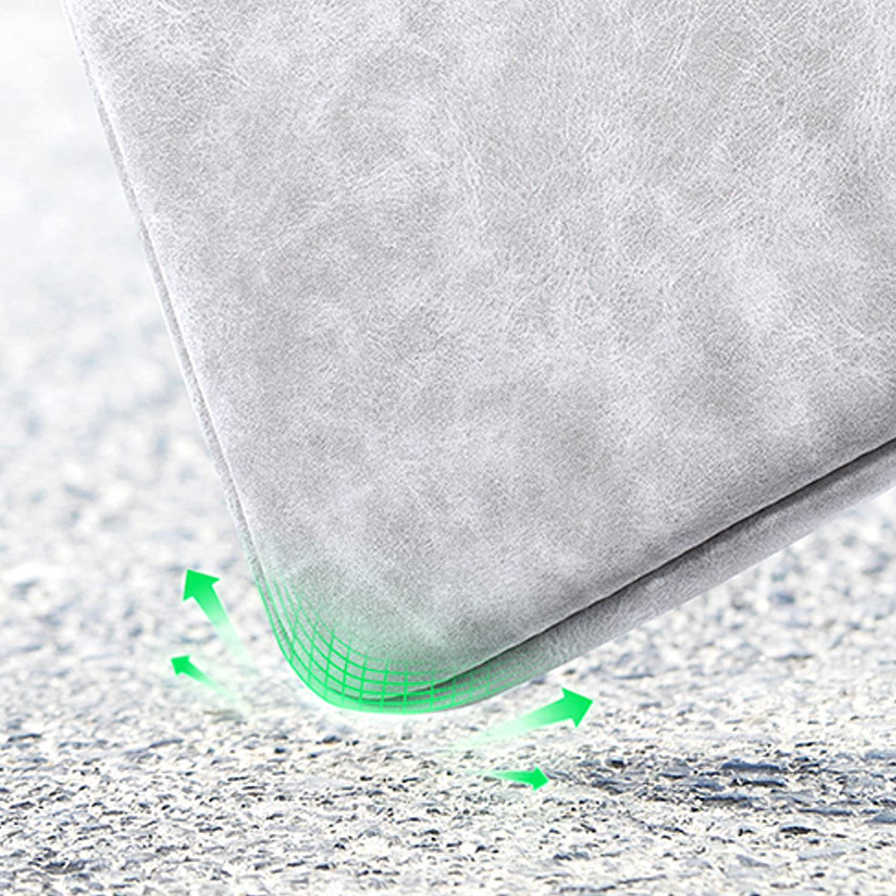 Szara tkanina na teksturowanej powierzchni, z zielonymi strzałkami wskazującymi amortyzację.