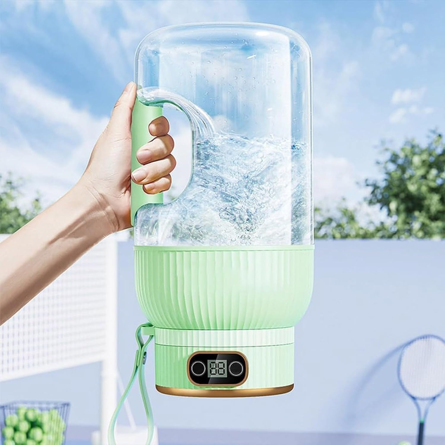 Hand hält einen grünen Wasserkocher mit Wasser gefüllt, draußen.