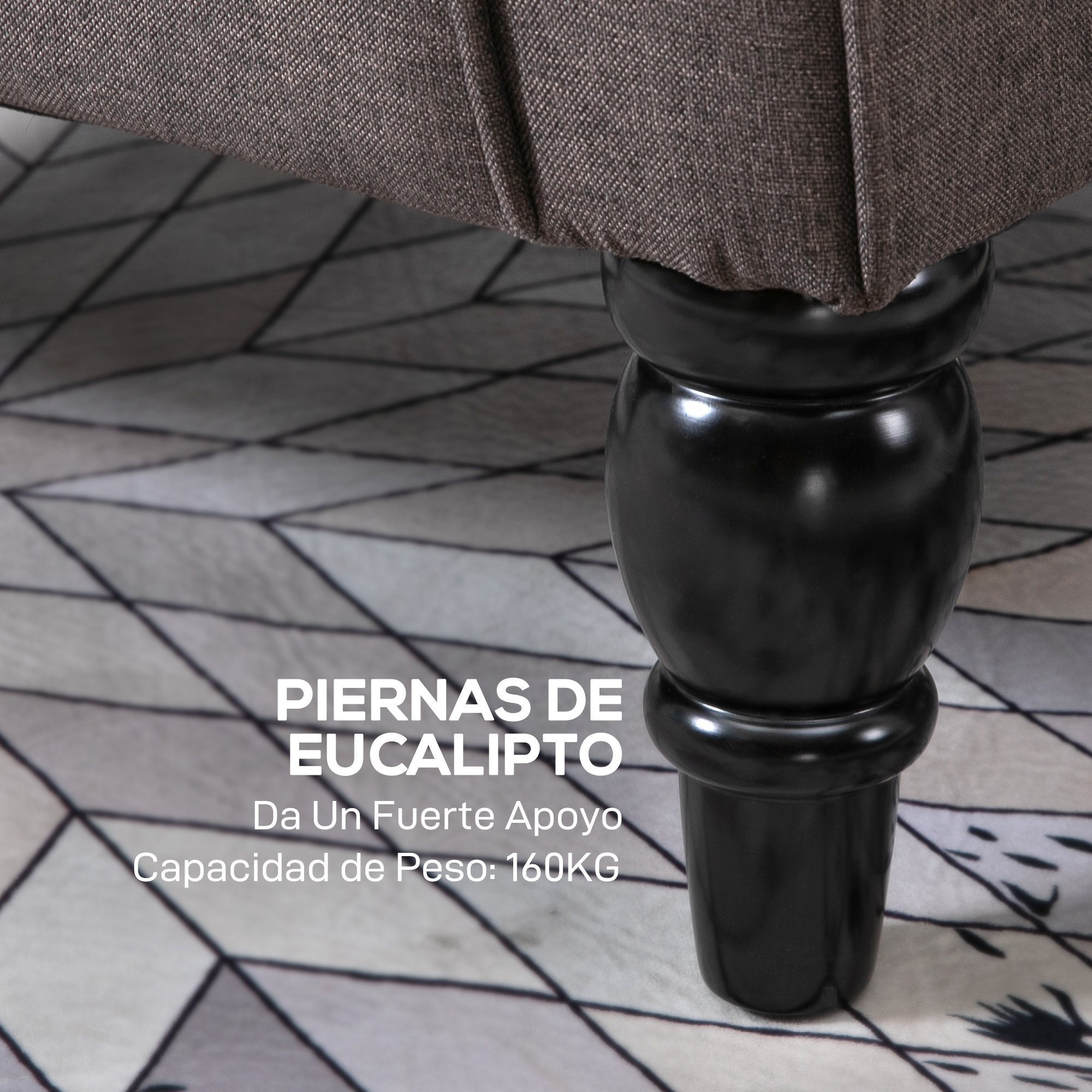 Una pata de madera negra torneada soporta tela gris. El suelo tiene un patrón geométrico.