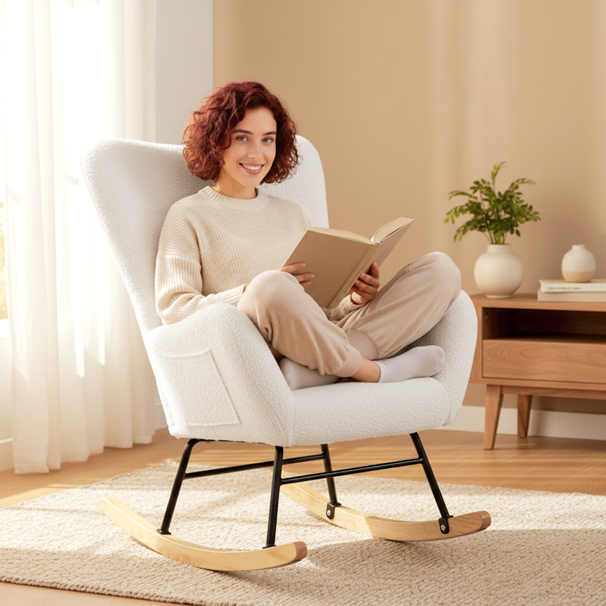 Mujer de pelo rojo lee un libro sentada en un sillón sobre una alfombra.