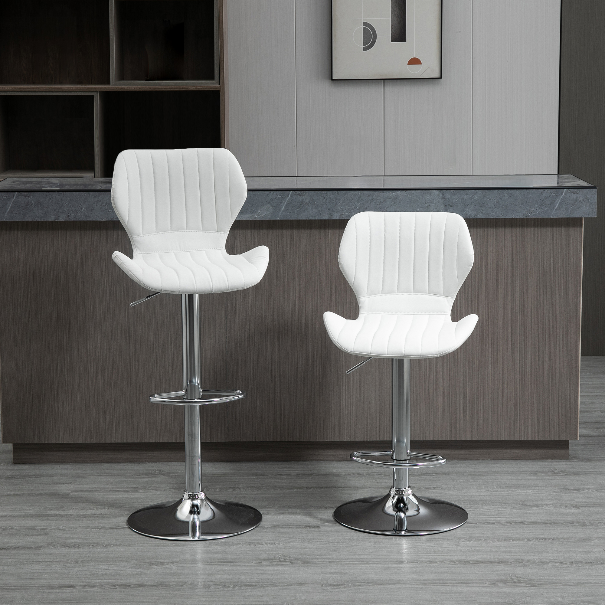 Dos taburetes altos blancos con base cromada frente a una barra de madera oscura.