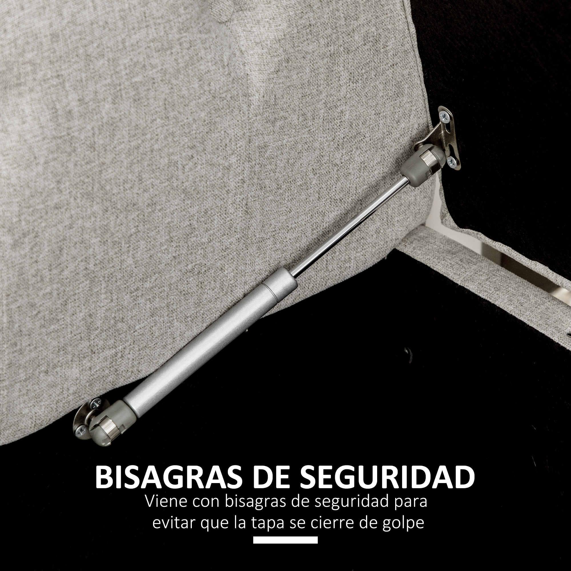 Un amortiguador de gas plateado está fijado a una tela gris.