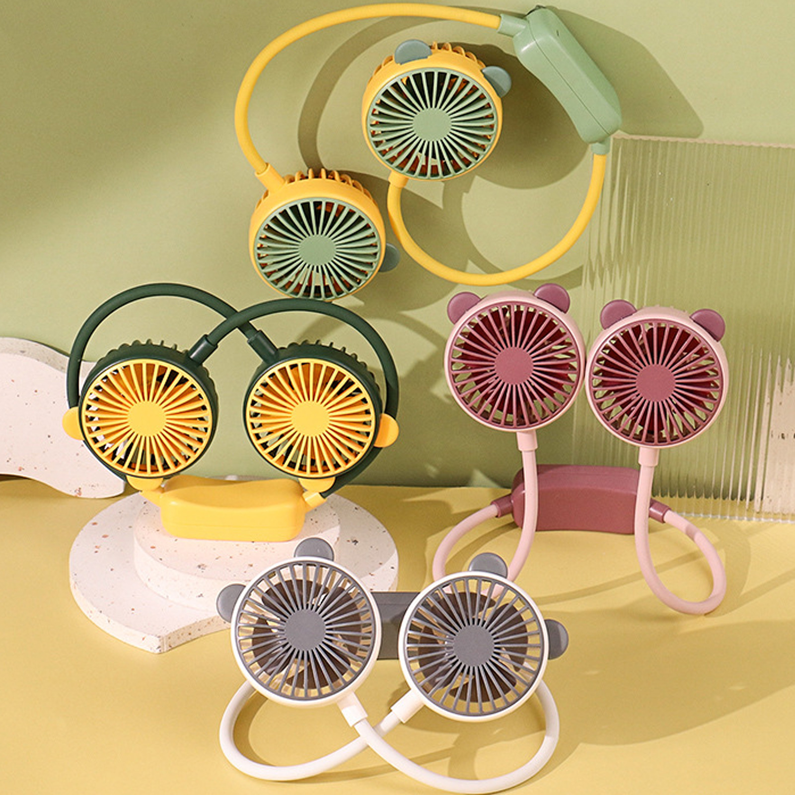 Mehrere Nackenventilatoren in Gelb, Grün, Rosa und Weiß mit Bärenohren.