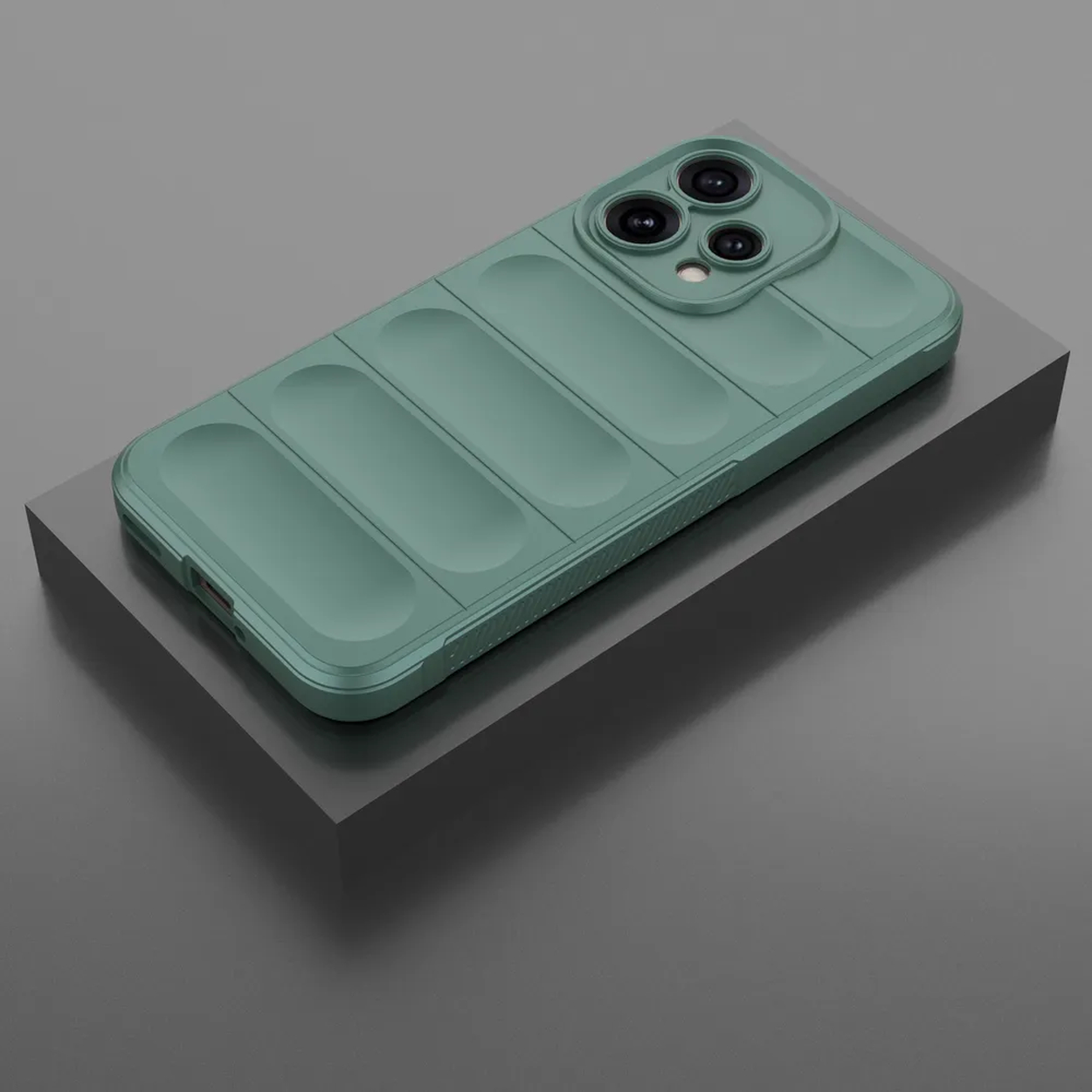 Une coque de téléphone verte à motif nervuré repose sur une plateforme grise.