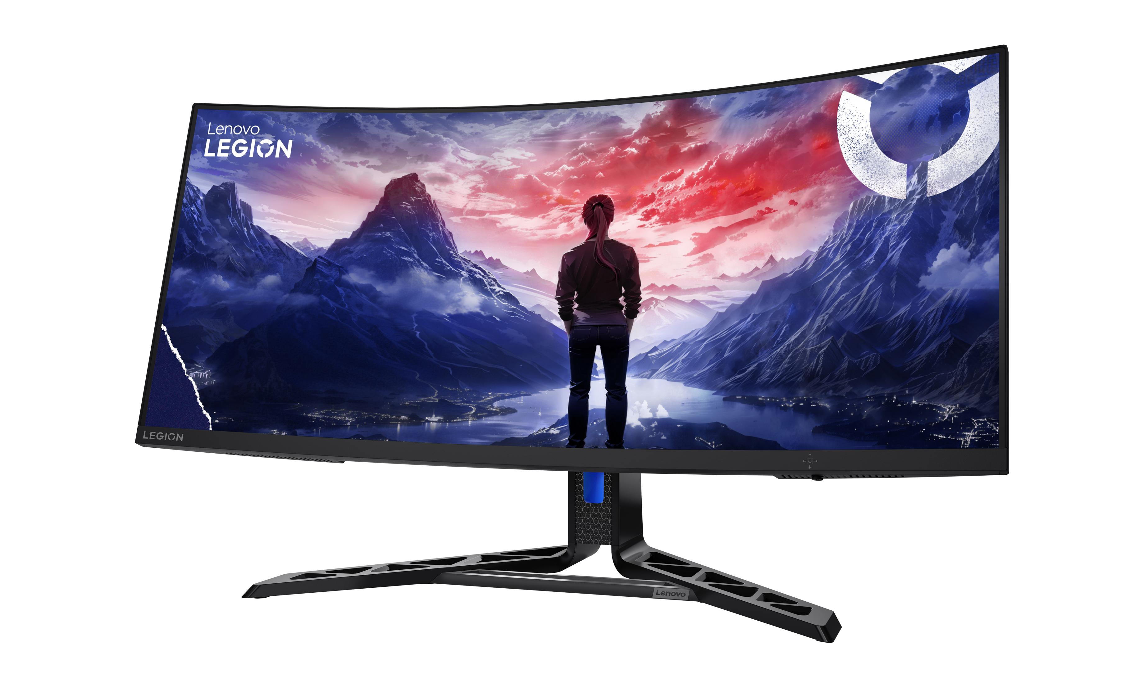 Kavisli Lenovo Legion monitör, dağ ve şehir manzarası, bakan bir kişi.