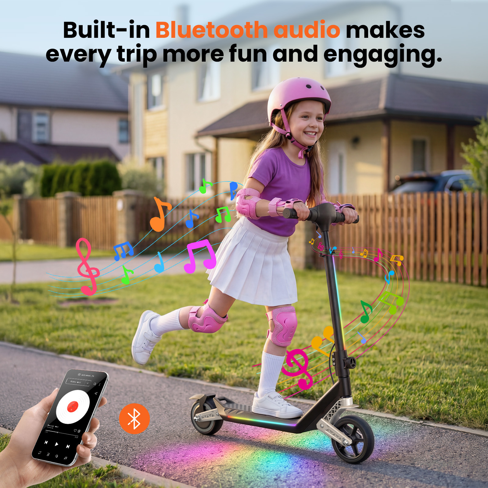 Dziewczynka jedzie na hulajnodze z nutami i światłami. Telefon obok.