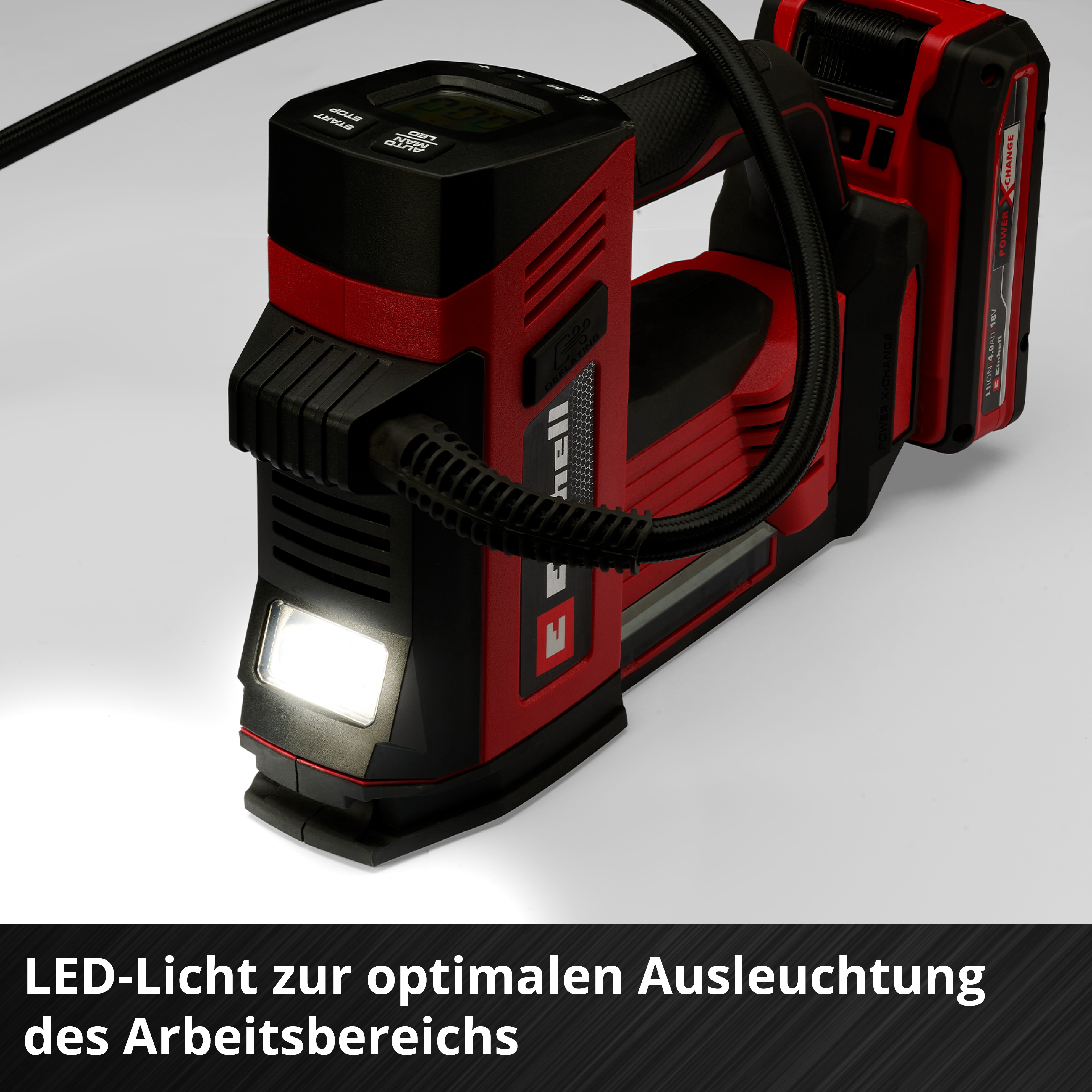 Un compressore senza fili rosso e nero con luce LED e tubo.