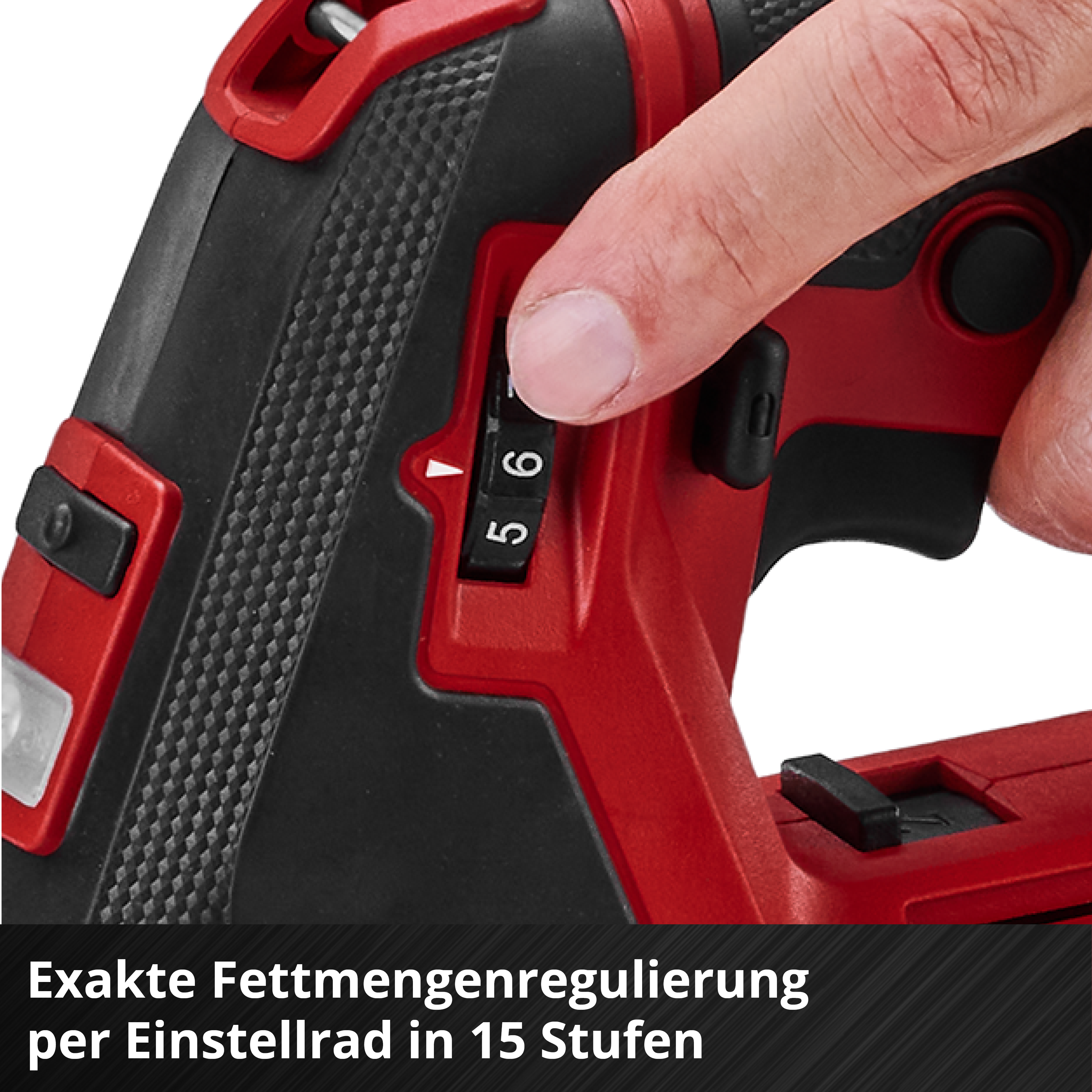 Hand stellt einen Regler auf einer roten und schwarzen Bohrmaschine ein.
