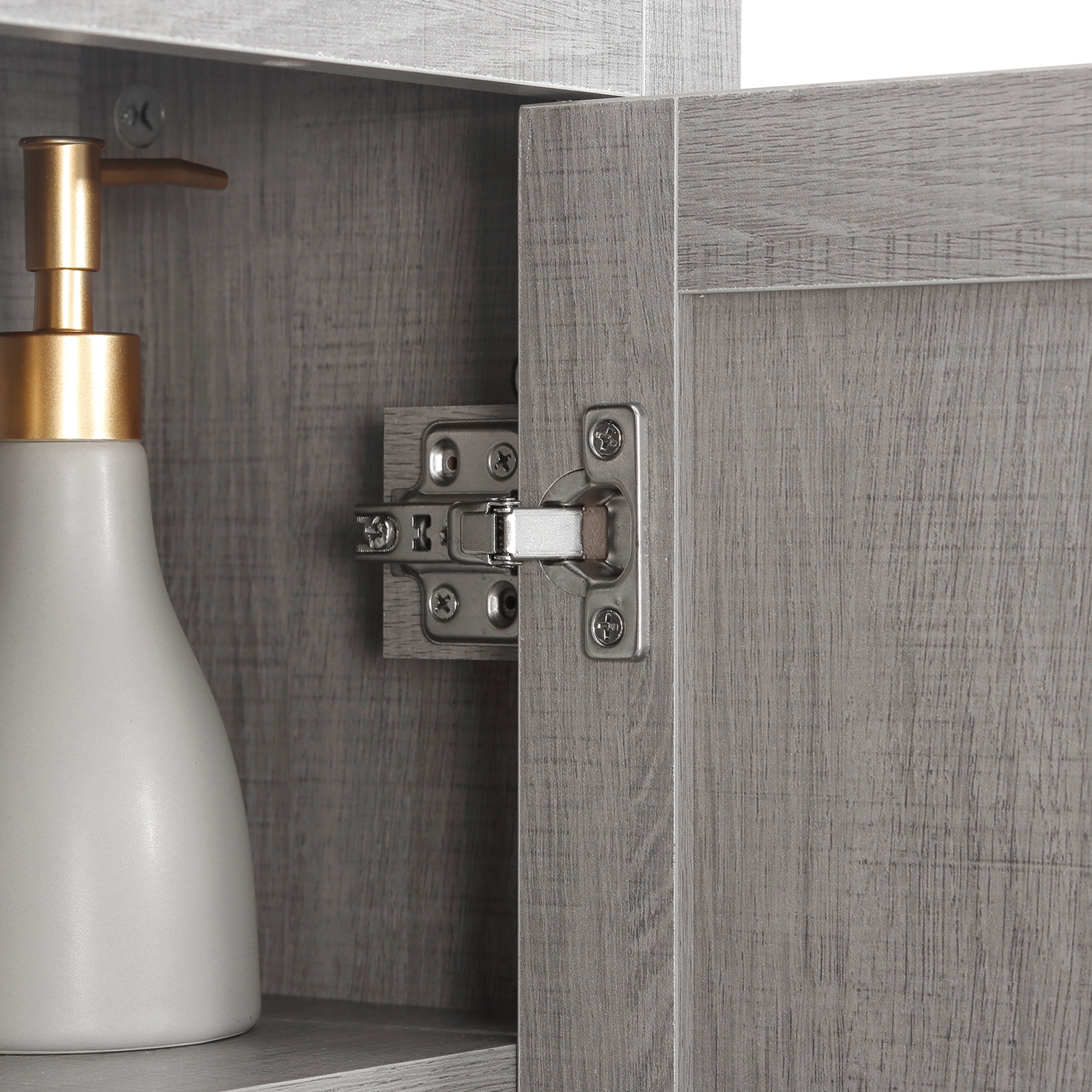 Gabinete gris con dispensador de jabón dorado y bisagra.