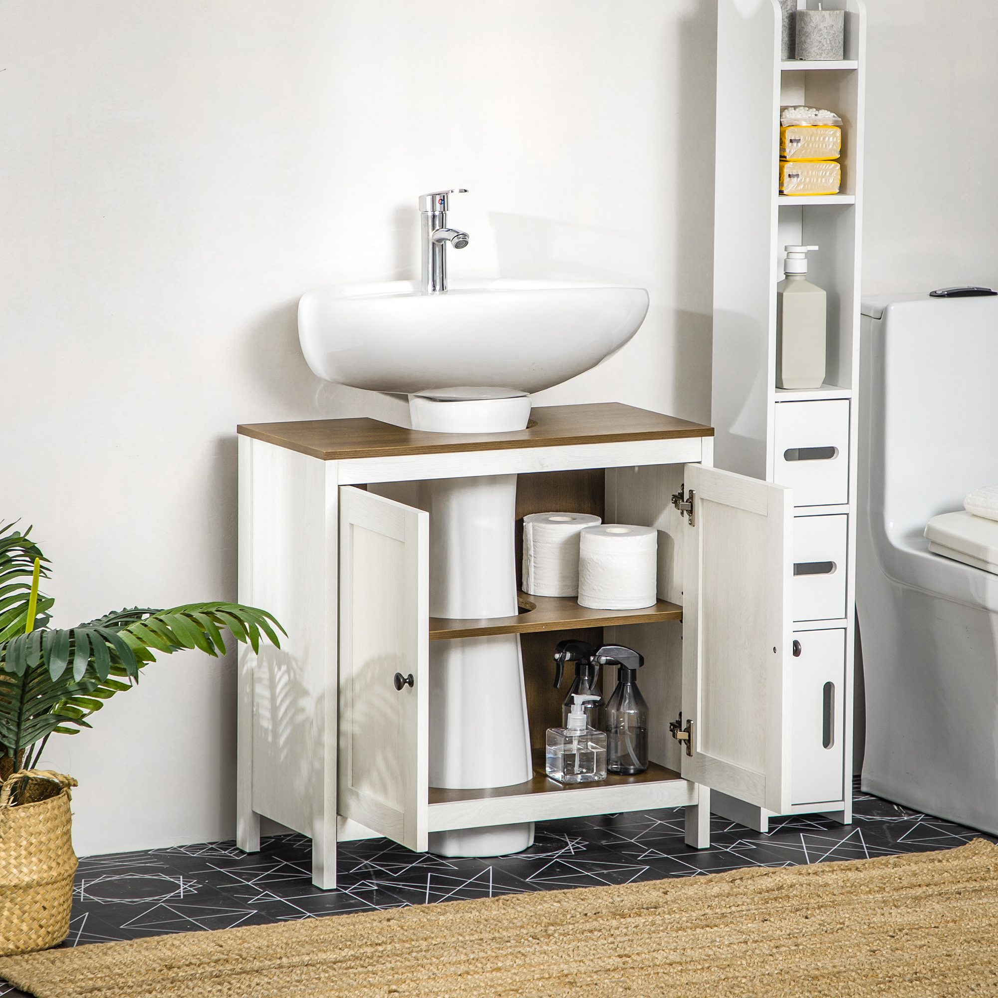 Un mueble de baño blanco con tapa de madera, lavabo, inodoro y plantas.
