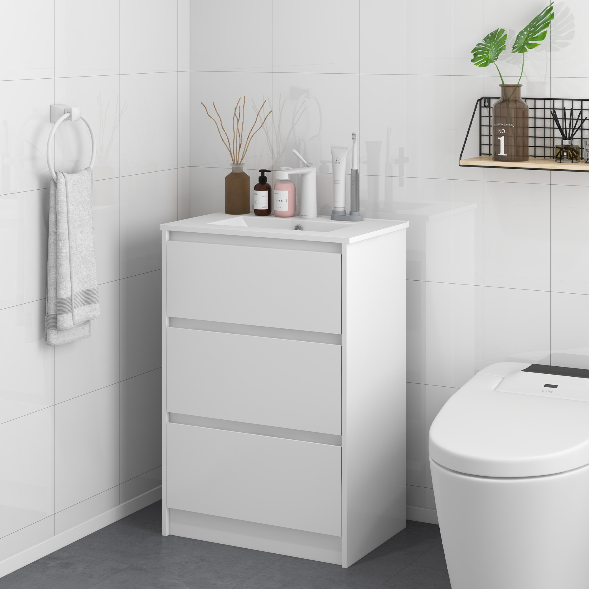 Un baño blanco con mueble de lavabo, inodoro y toallero.
