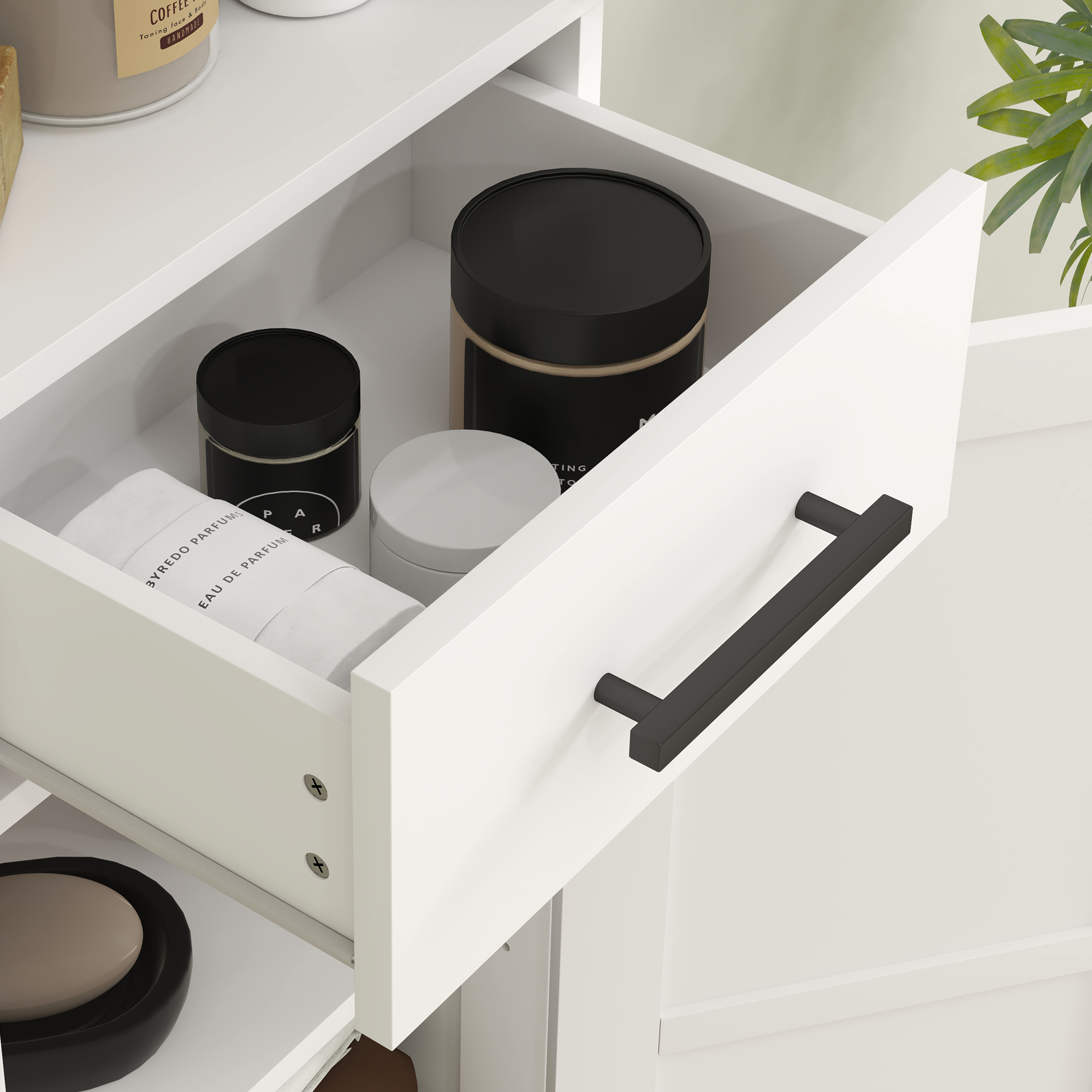 Cajón blanco con tirador negro, contiene frascos de cuidado de la piel y una toalla enrollada.