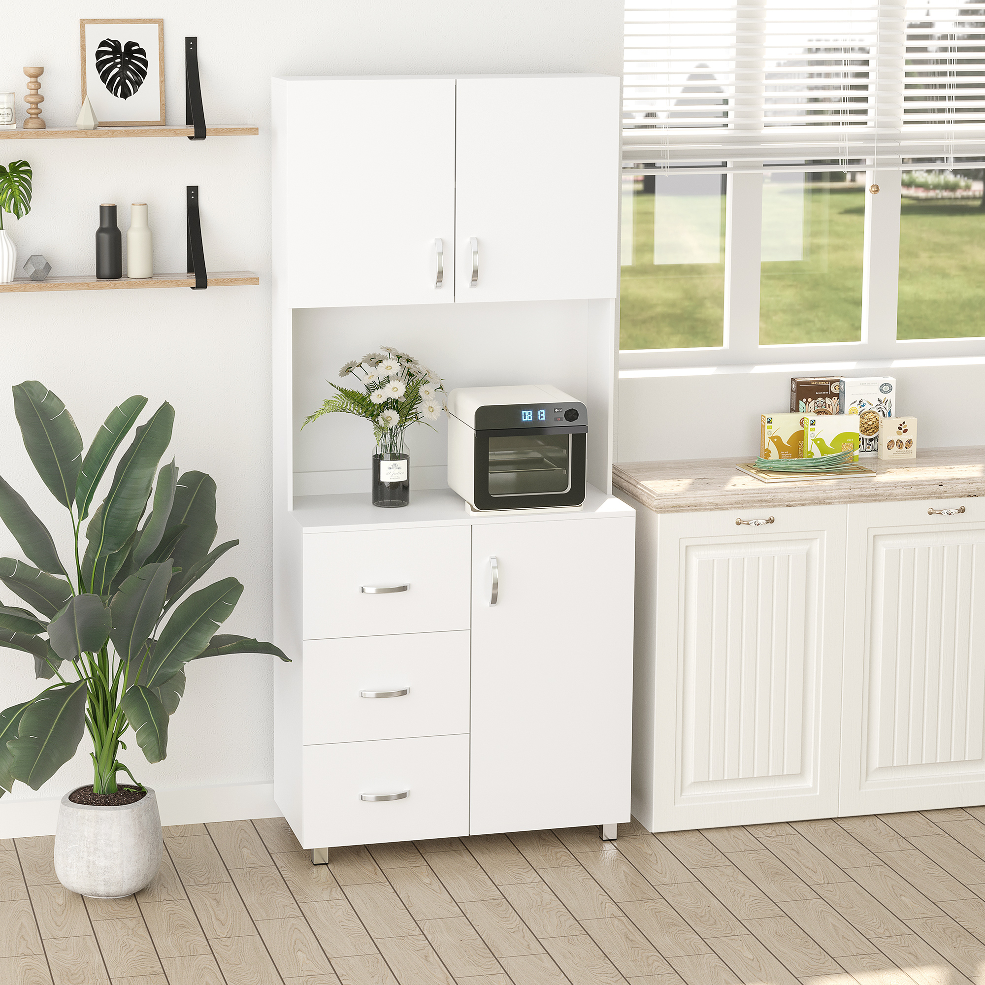 Un set de gabinetes de cocina blancos con puertas de vidrio y cajones. Una planta a la izquierda.