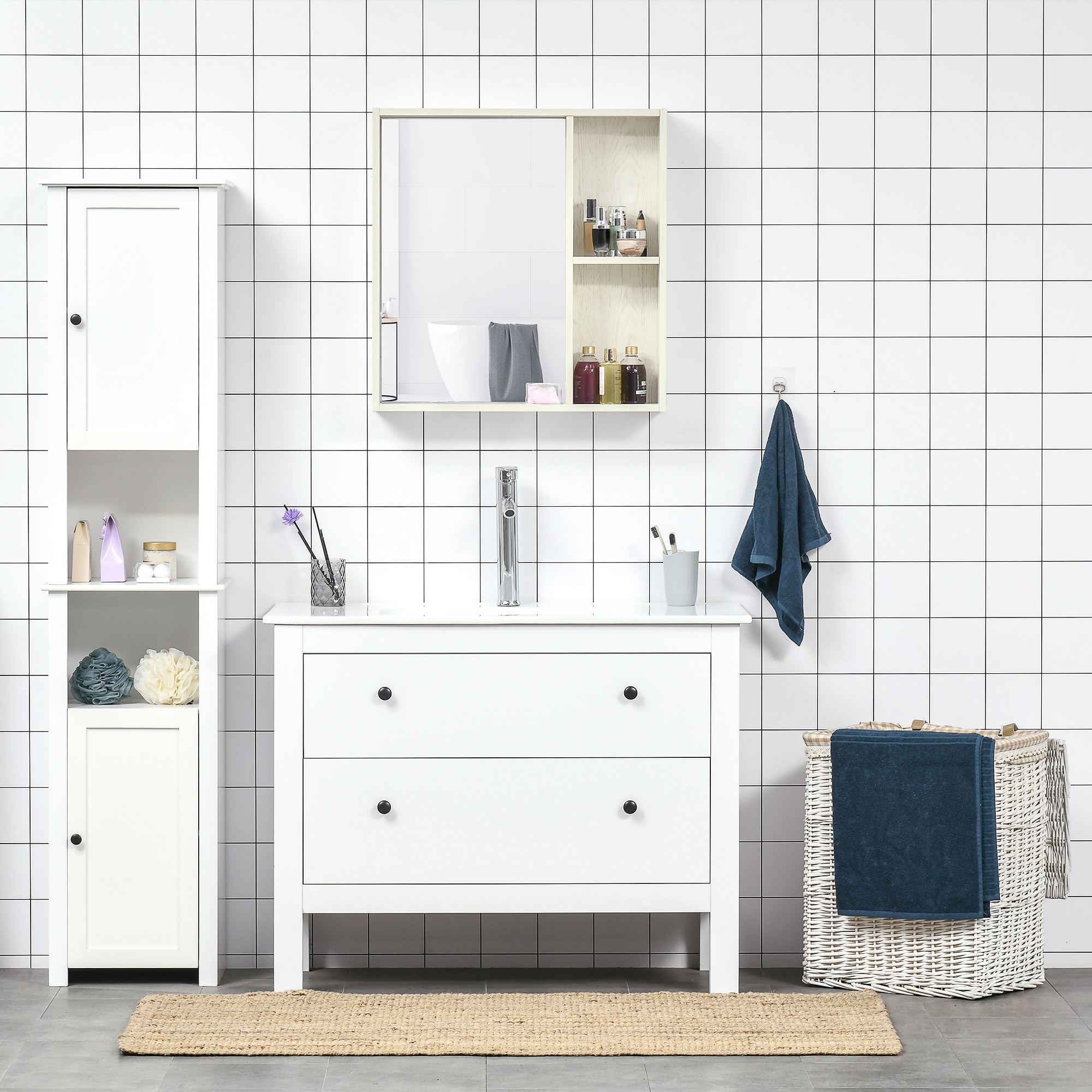 Un baño con azulejos blancos, un tocador blanco y un armario alto.