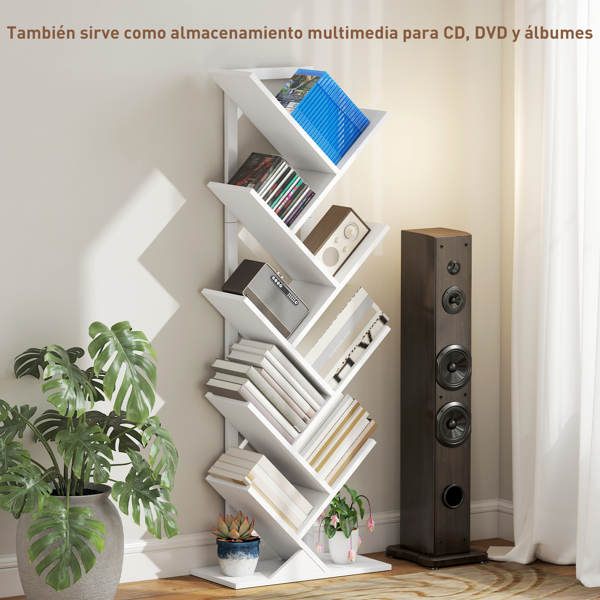 Estantería blanca con libros, CDs y altavoces junto a una planta.