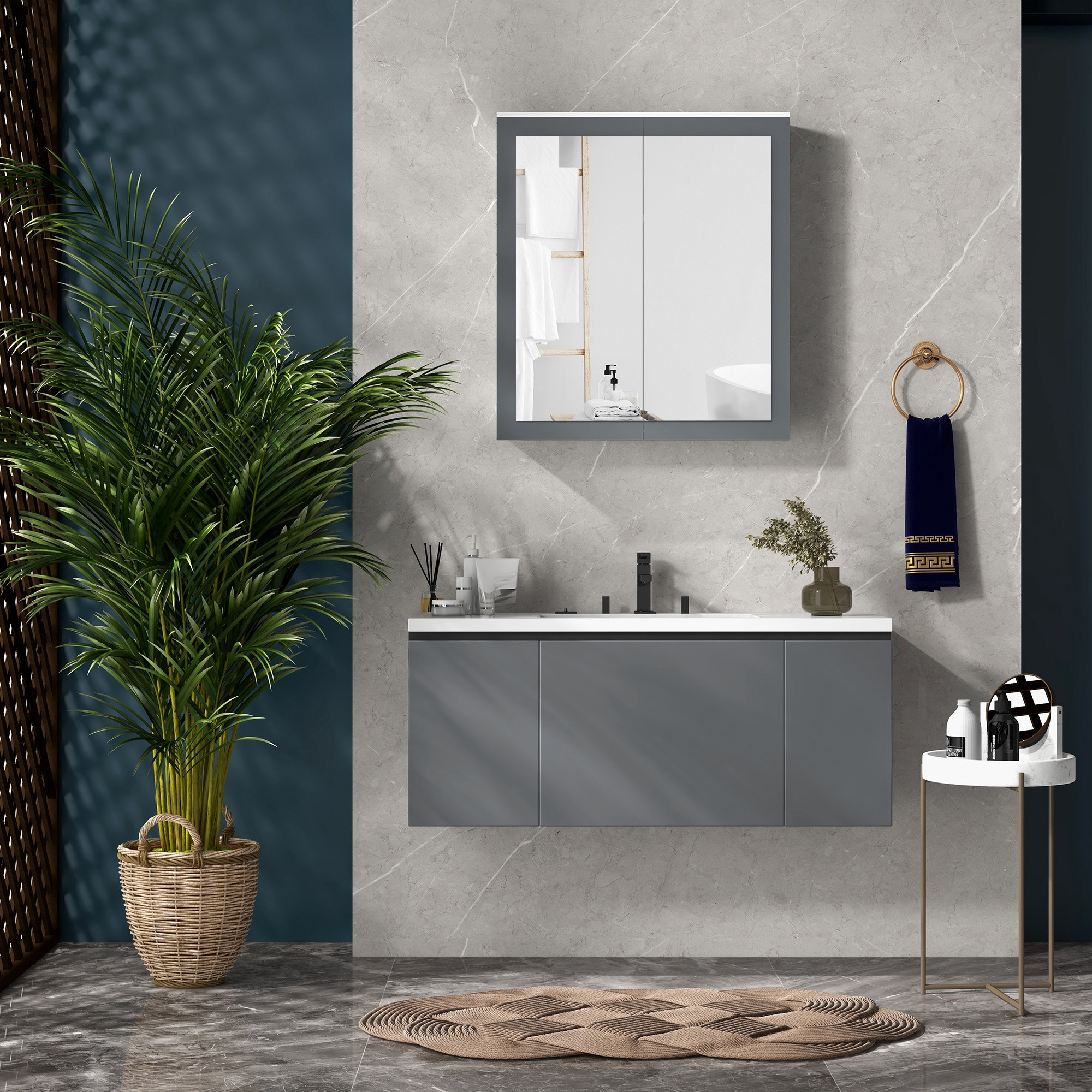 Un baño moderno con tocador gris, espejo, planta y toallero.
