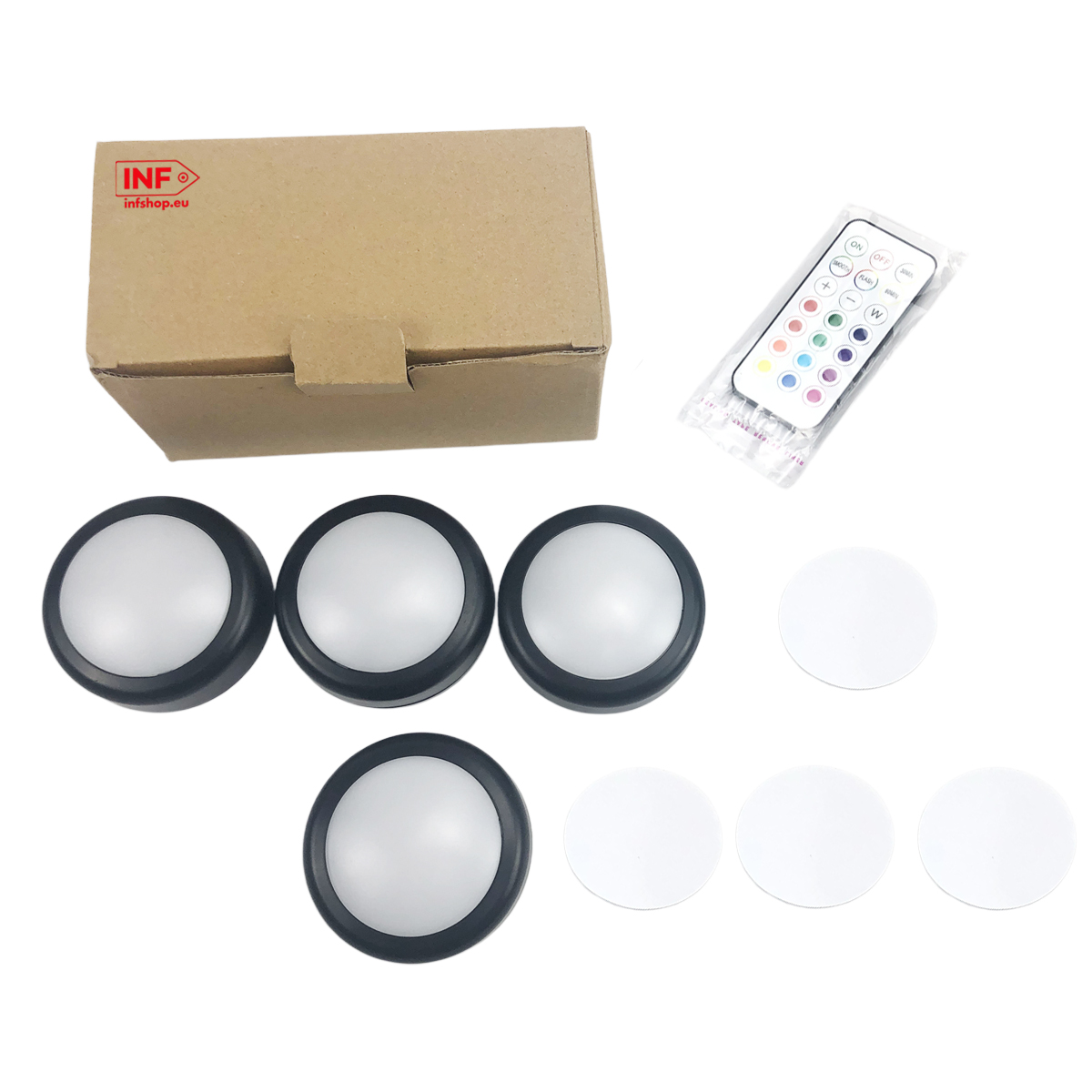 Kartonowe pudełko, cztery okrągłe lampy, pilot i cztery białe krążki.
