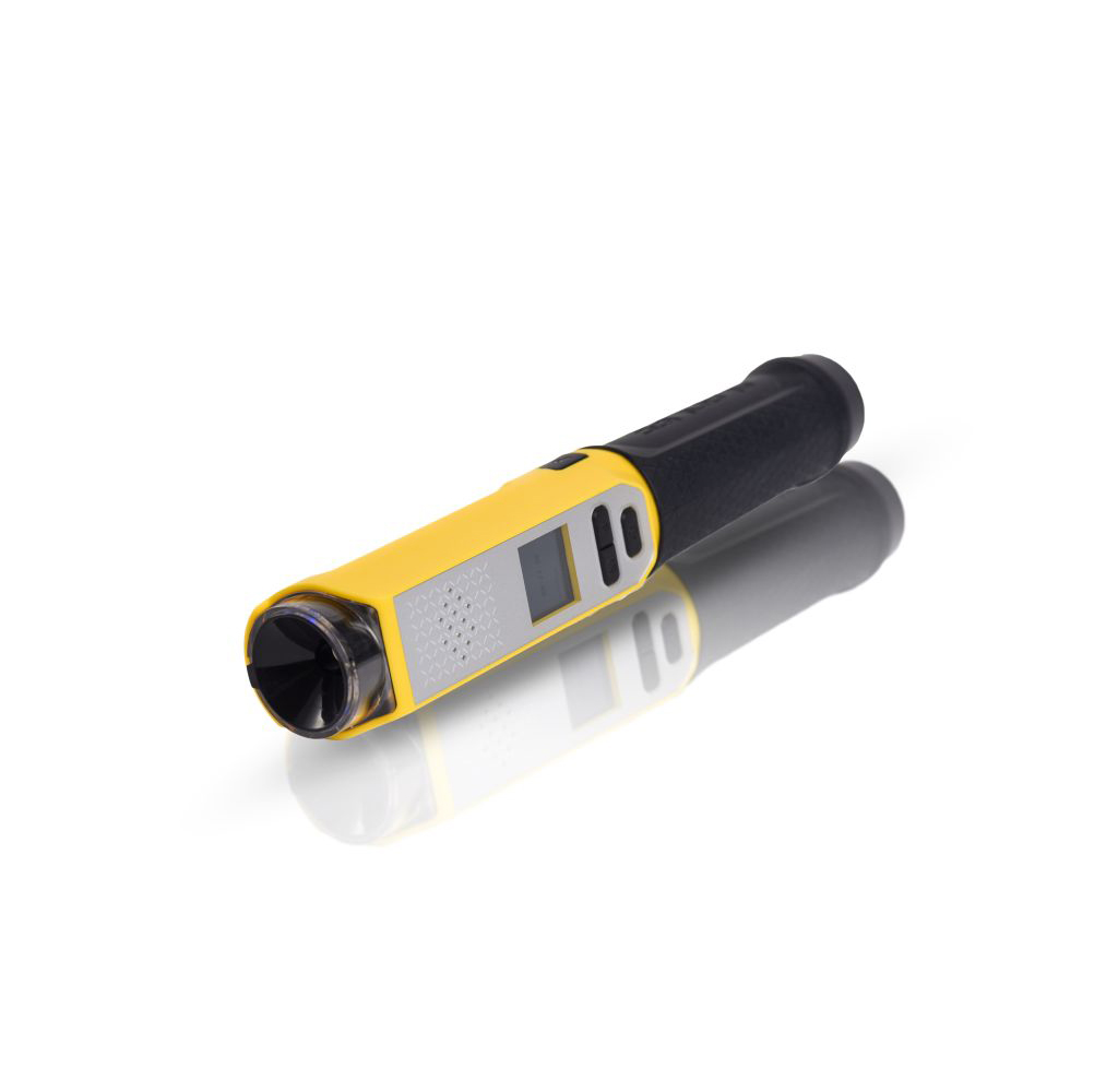 Żółto-czarny alkomat z małym ekranem i odblaskową podstawą.