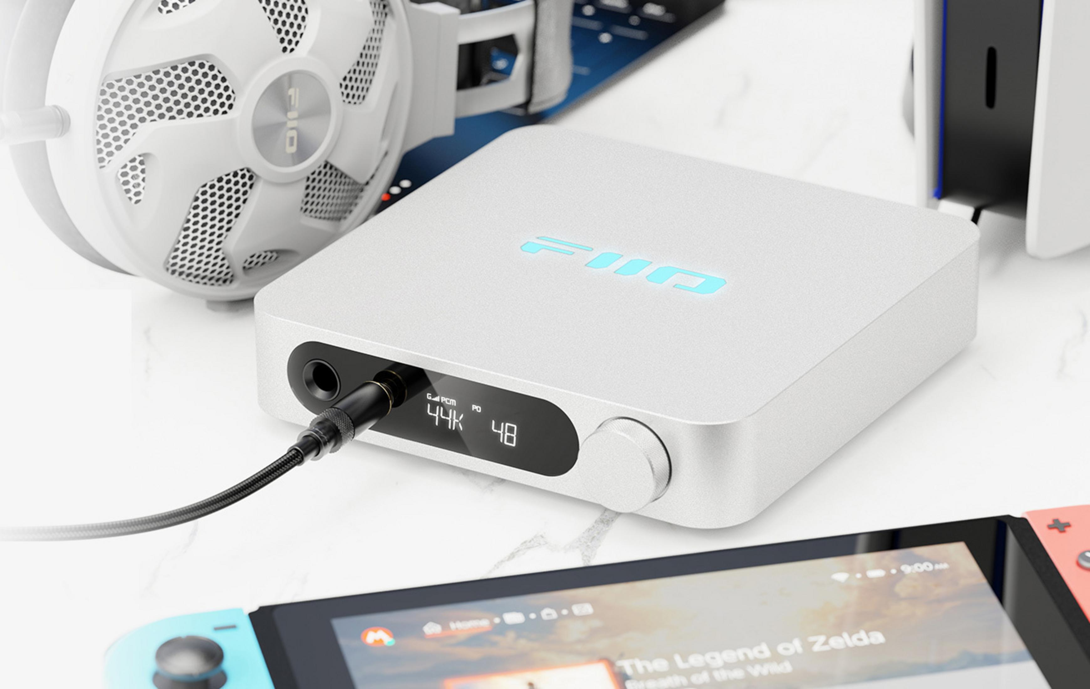 Biały DAC FiiO ze słuchawkami i konsolą Nintendo Switch.