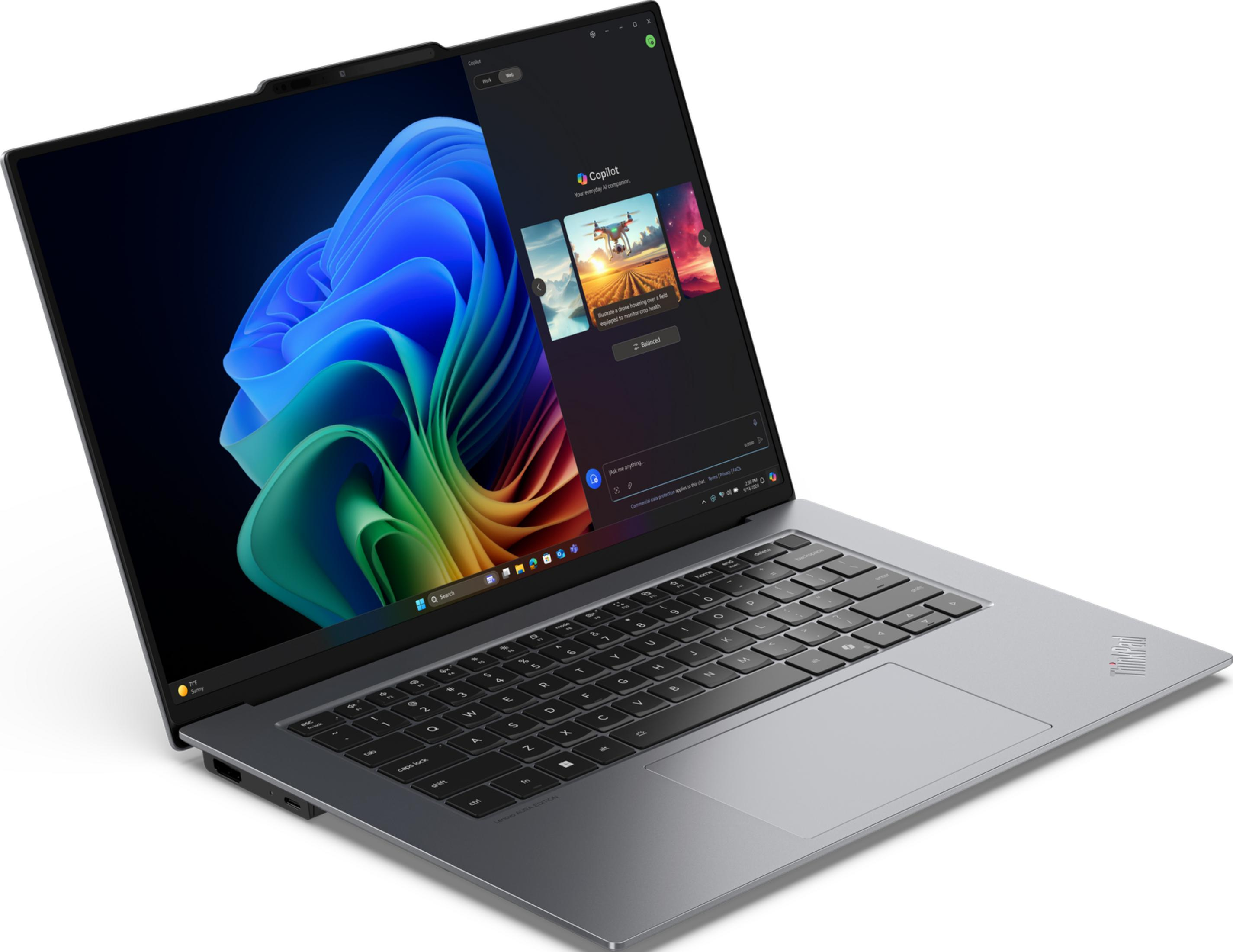 Szary laptop wyświetlający kolorową tapetę na ekranie.