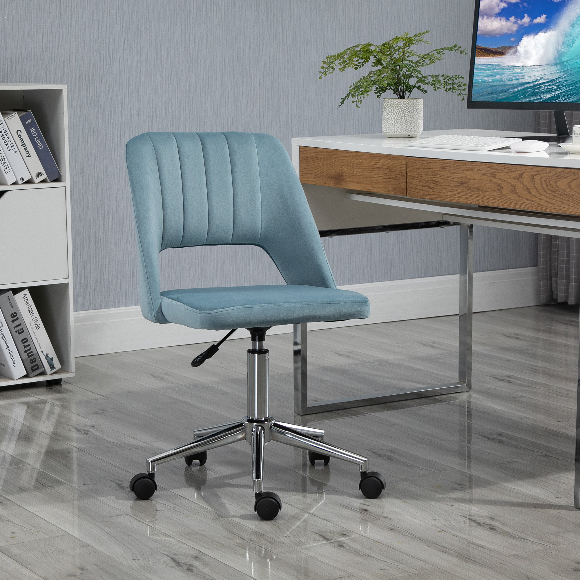 Ein blauer Bürostuhl steht vor einem Schreibtisch mit einem Computer.