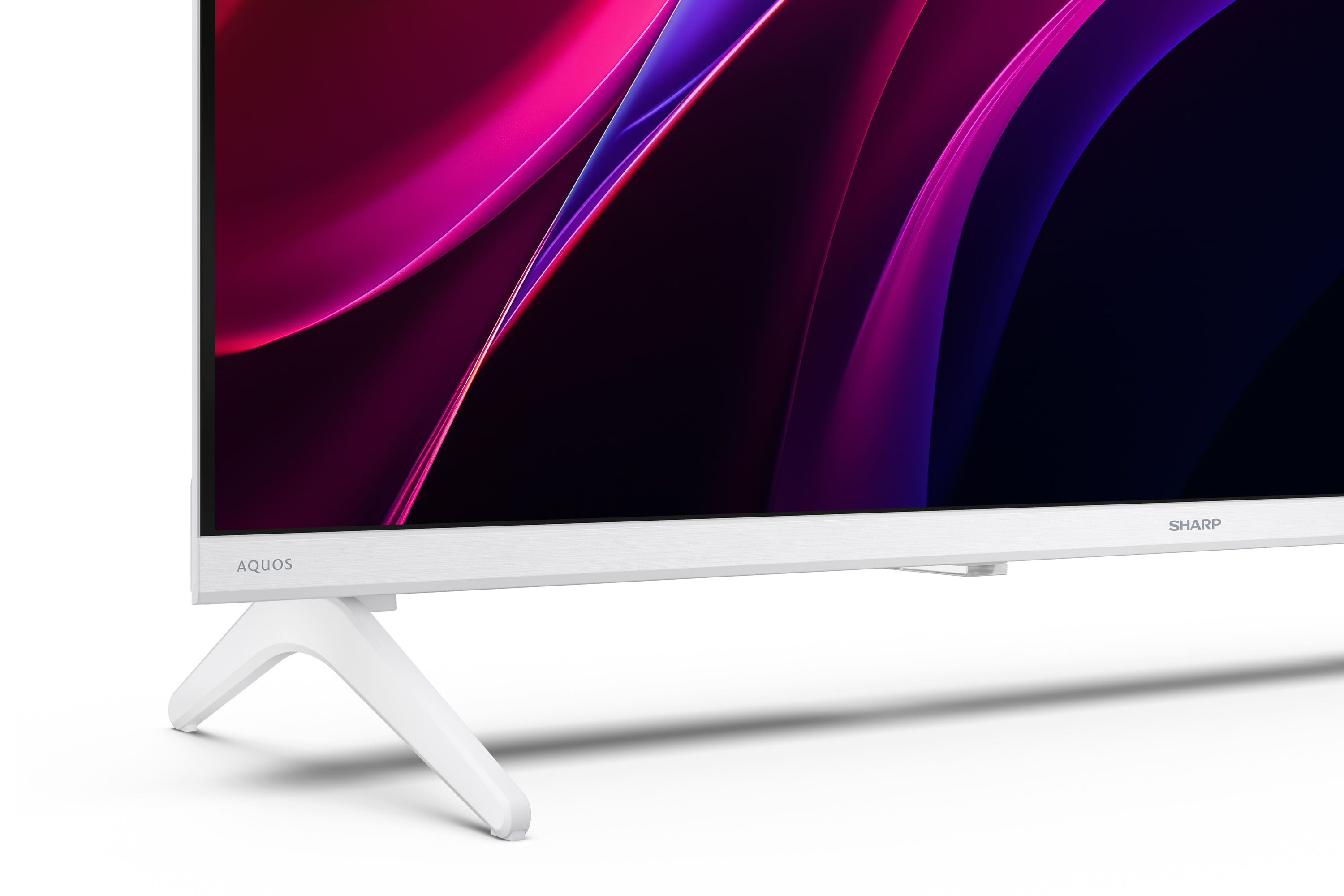 Una TV bianca con logo AQUOS mostra onde astratte viola e blu sullo schermo.
