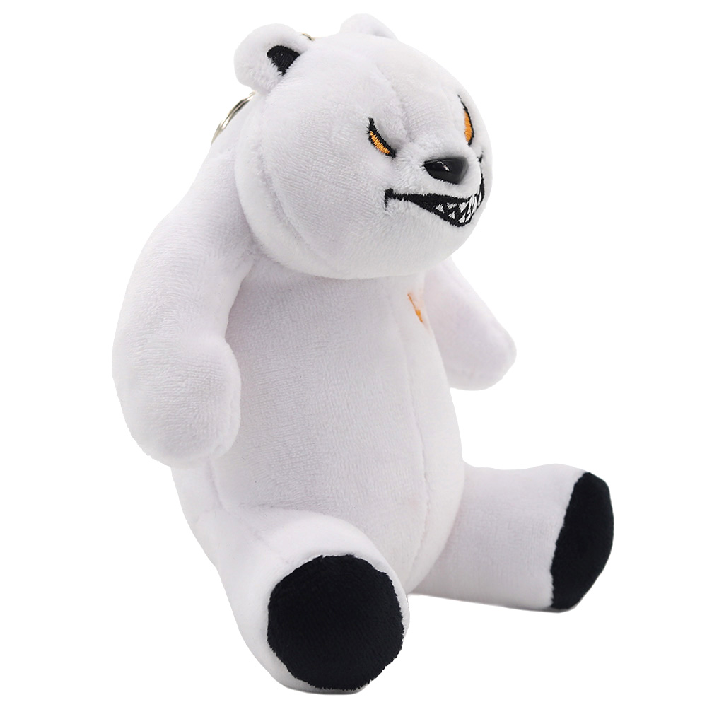 Ein weißer Teddybär mit bösem Gesichtsausdruck sitzt und hat schwarze Füße.