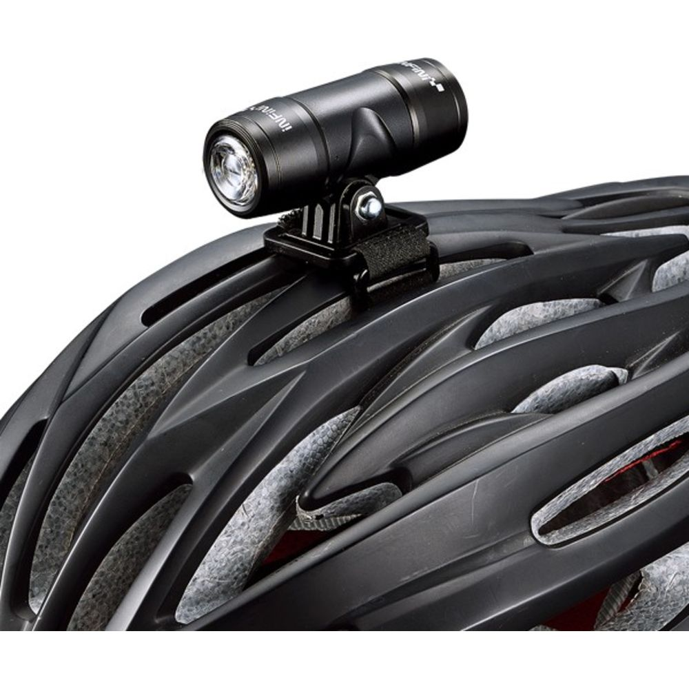 Schwarzer Fahrradhelm mit einer kleinen schwarzen Leuchte oben.