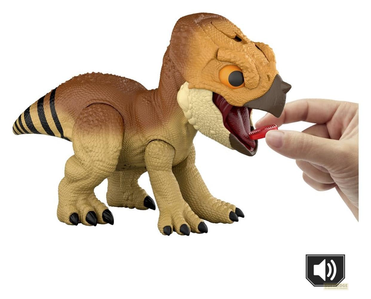 Dinosaurio marrón con ojo naranja y cola a rayas come anillo rojo.