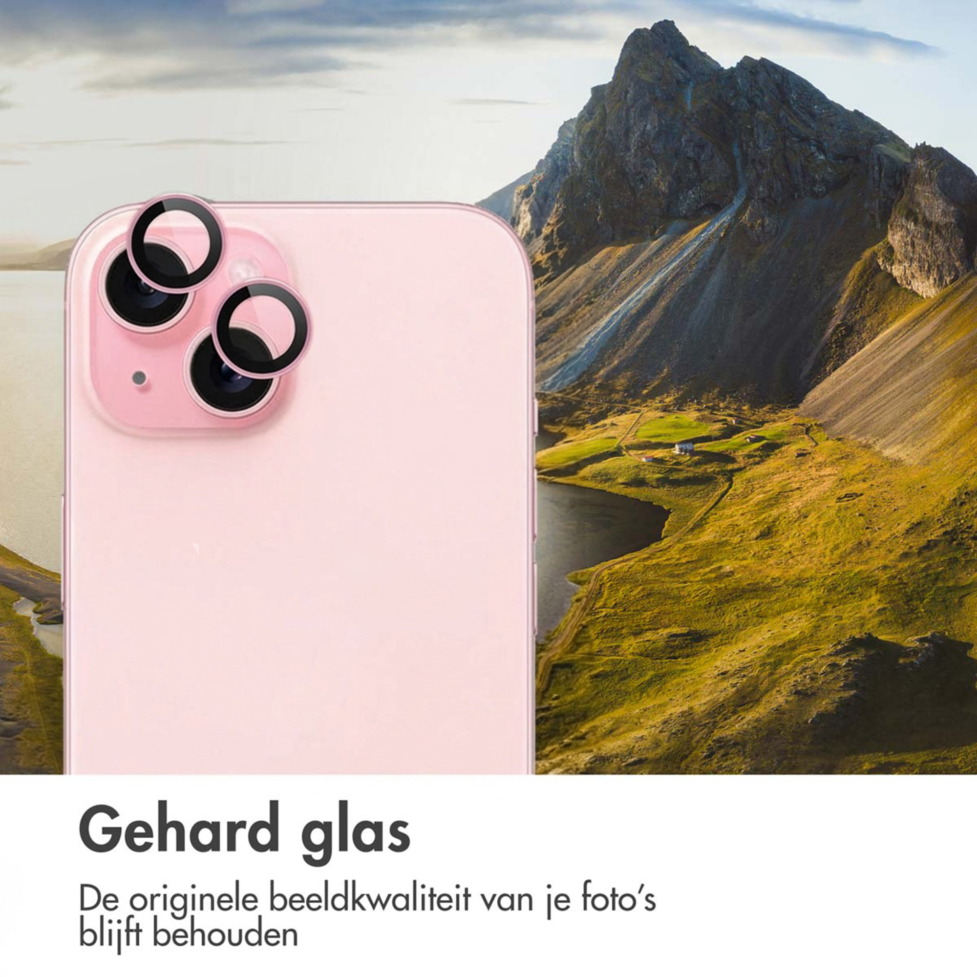 A pink smartphone with camera lens protectors in front of a mountain landscape.