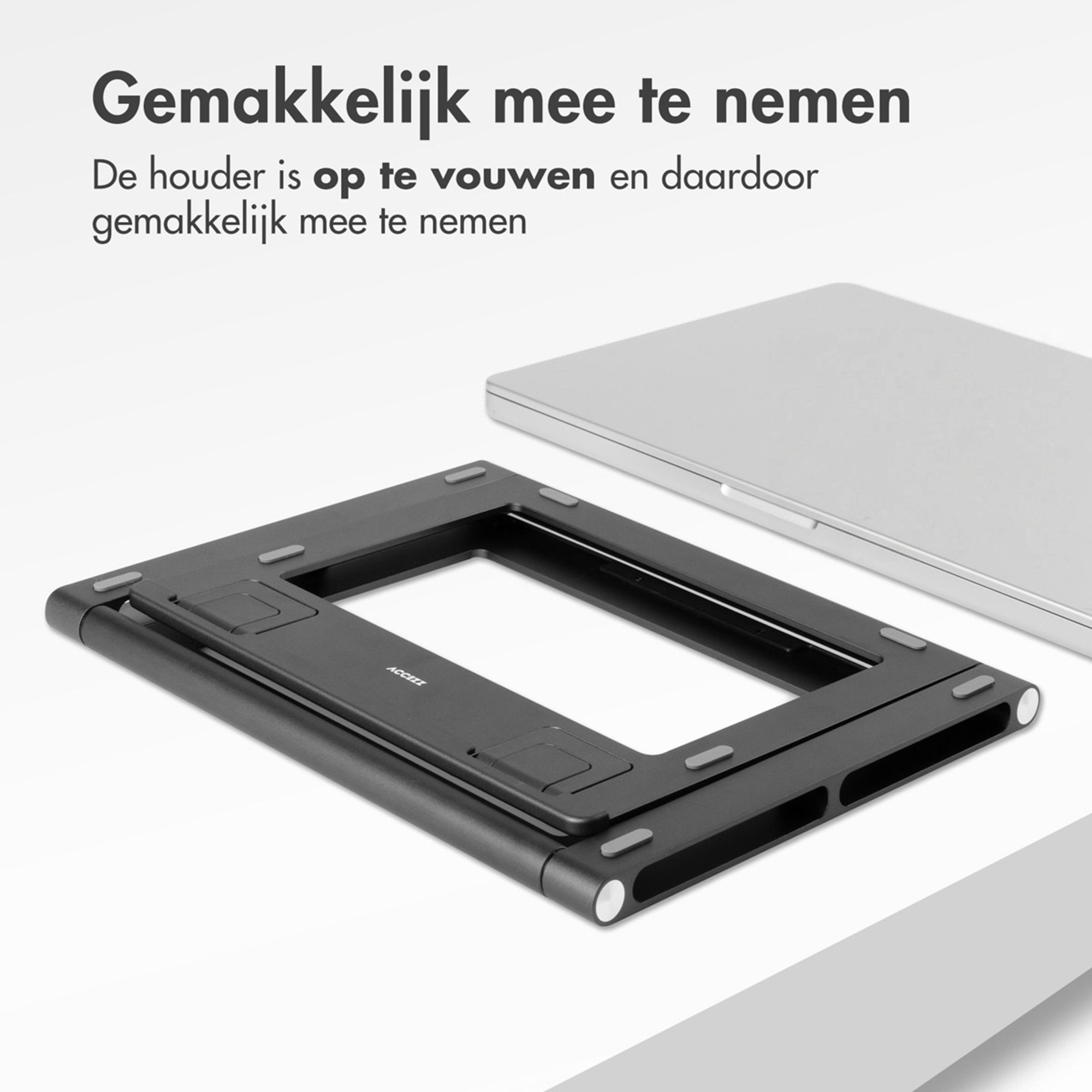 A foldable black metal laptop stand next to a laptop.
