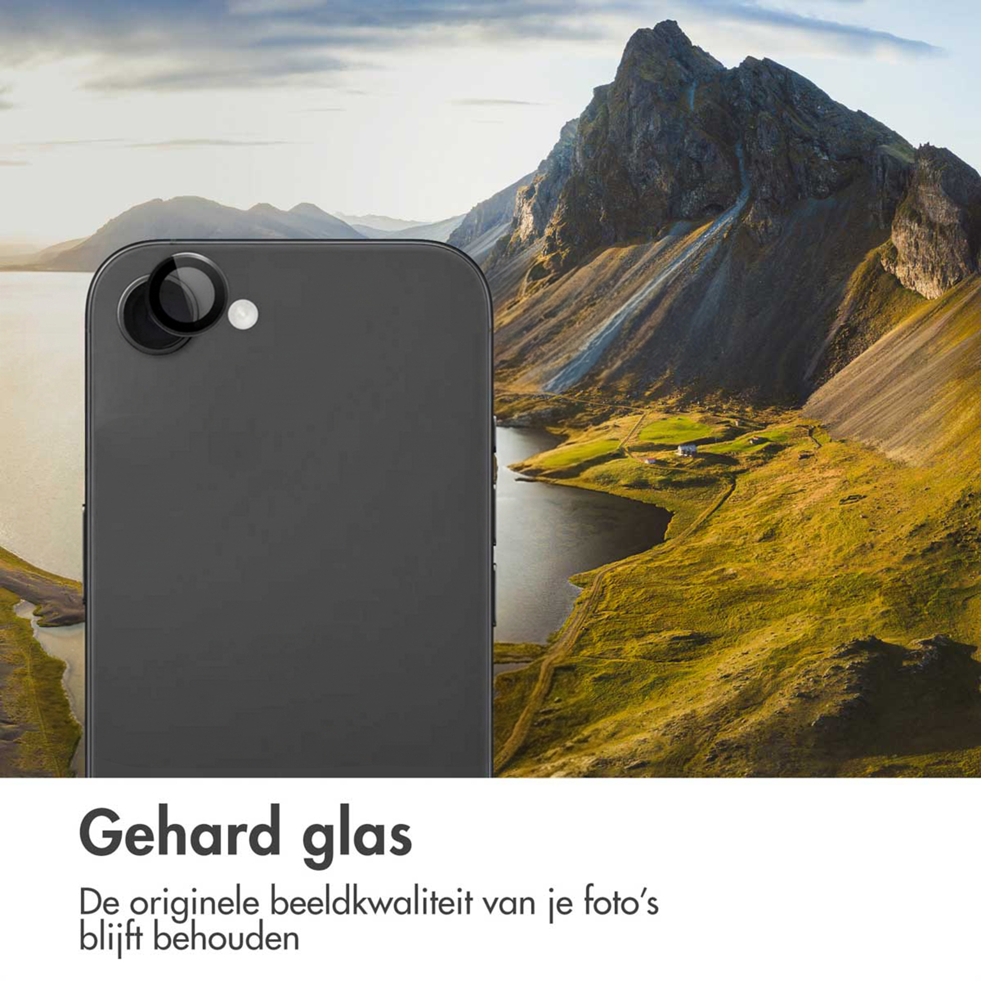 Téléphone gris avec deux caméras devant un paysage de montagne avec lac.