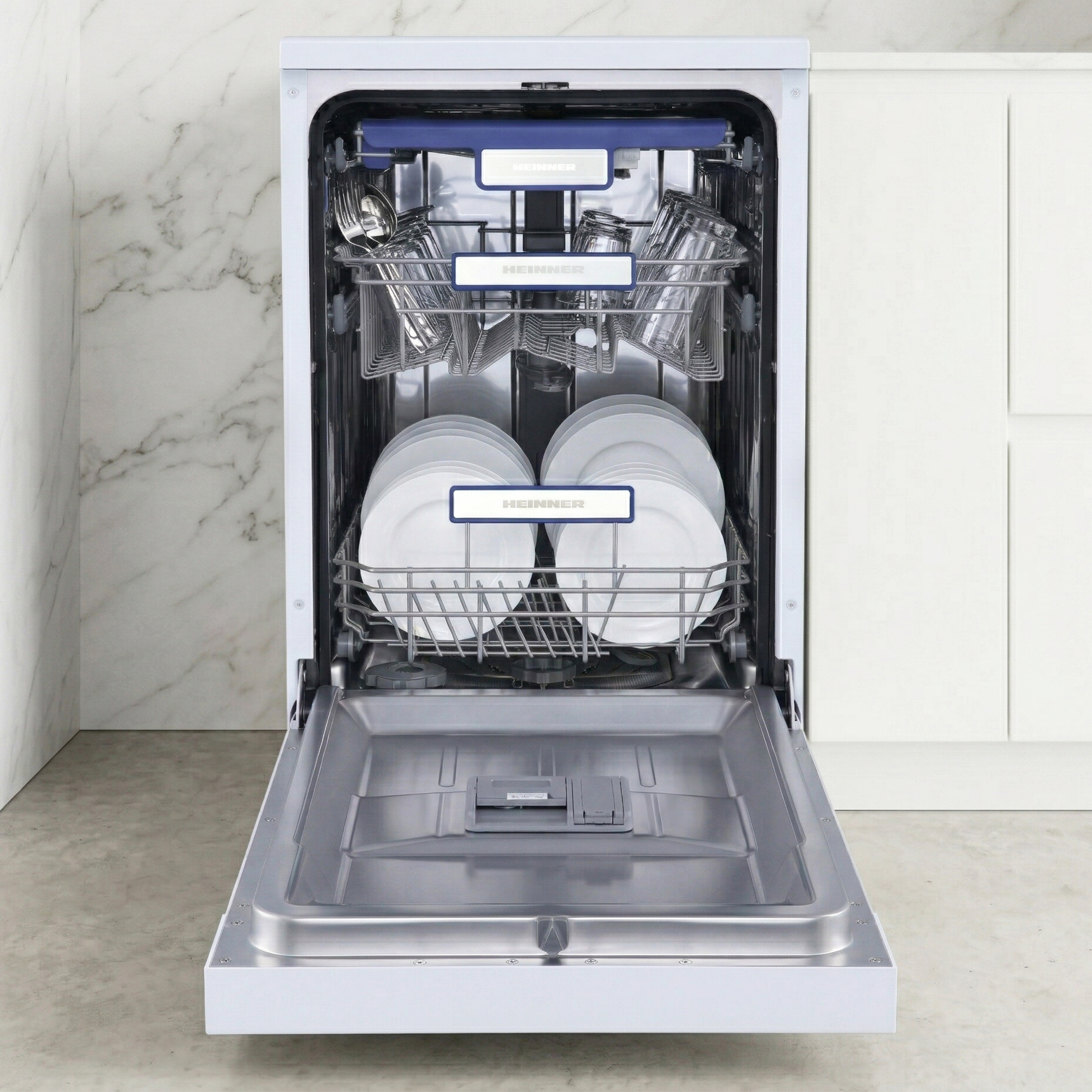 Open dishwasher with full racks: plates below, glasses and cutlery above.