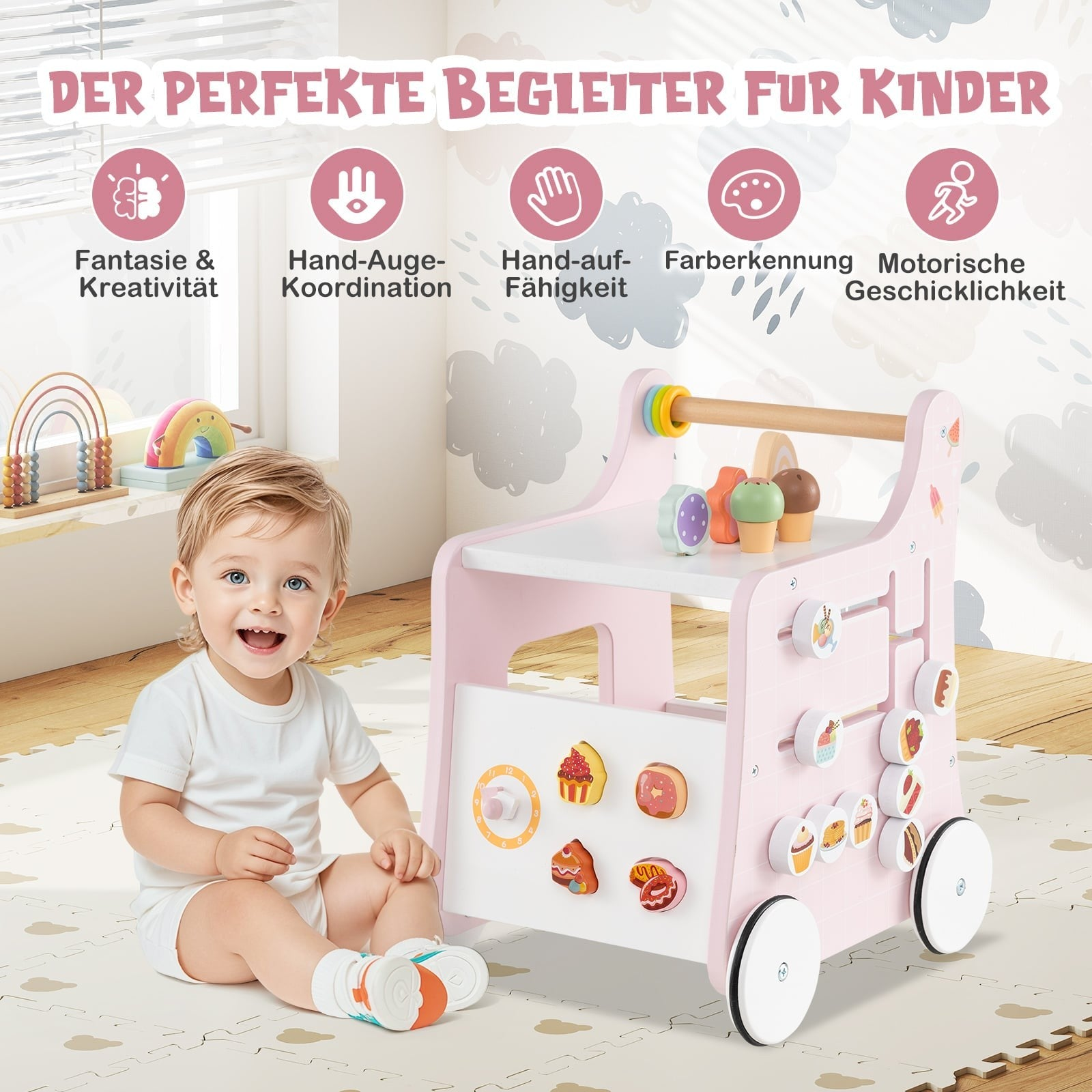 Een baby zit naast een roze speelgoedloopstoel met veel kleurrijk speelgoed.