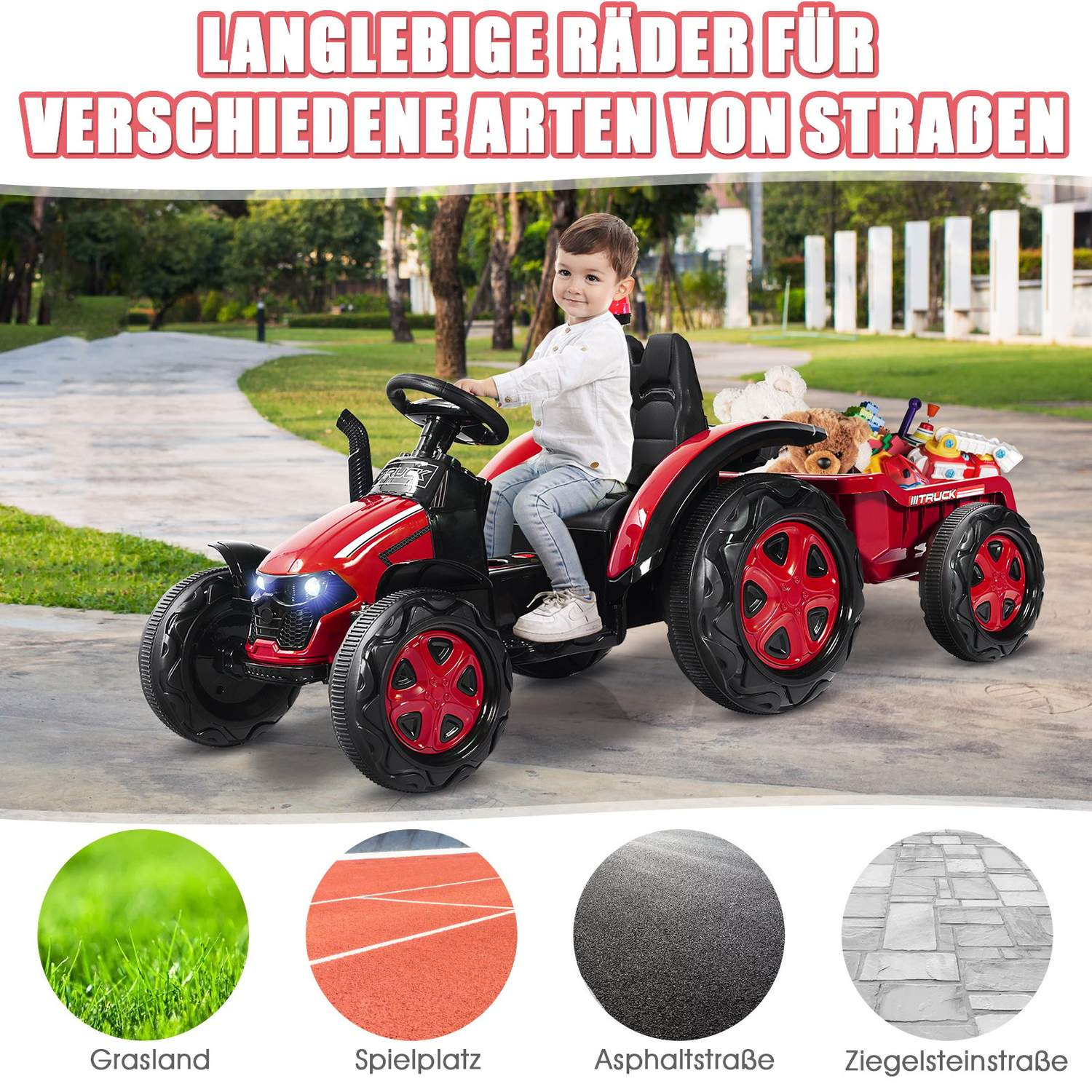 A child rides a red toy tractor with a trailer outdoors.