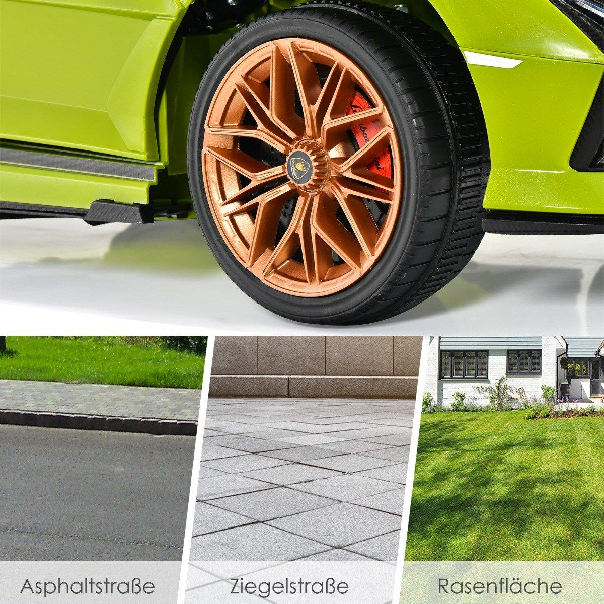 Green toy car wheel with copper rim over asphalt, paver stones, and grass.