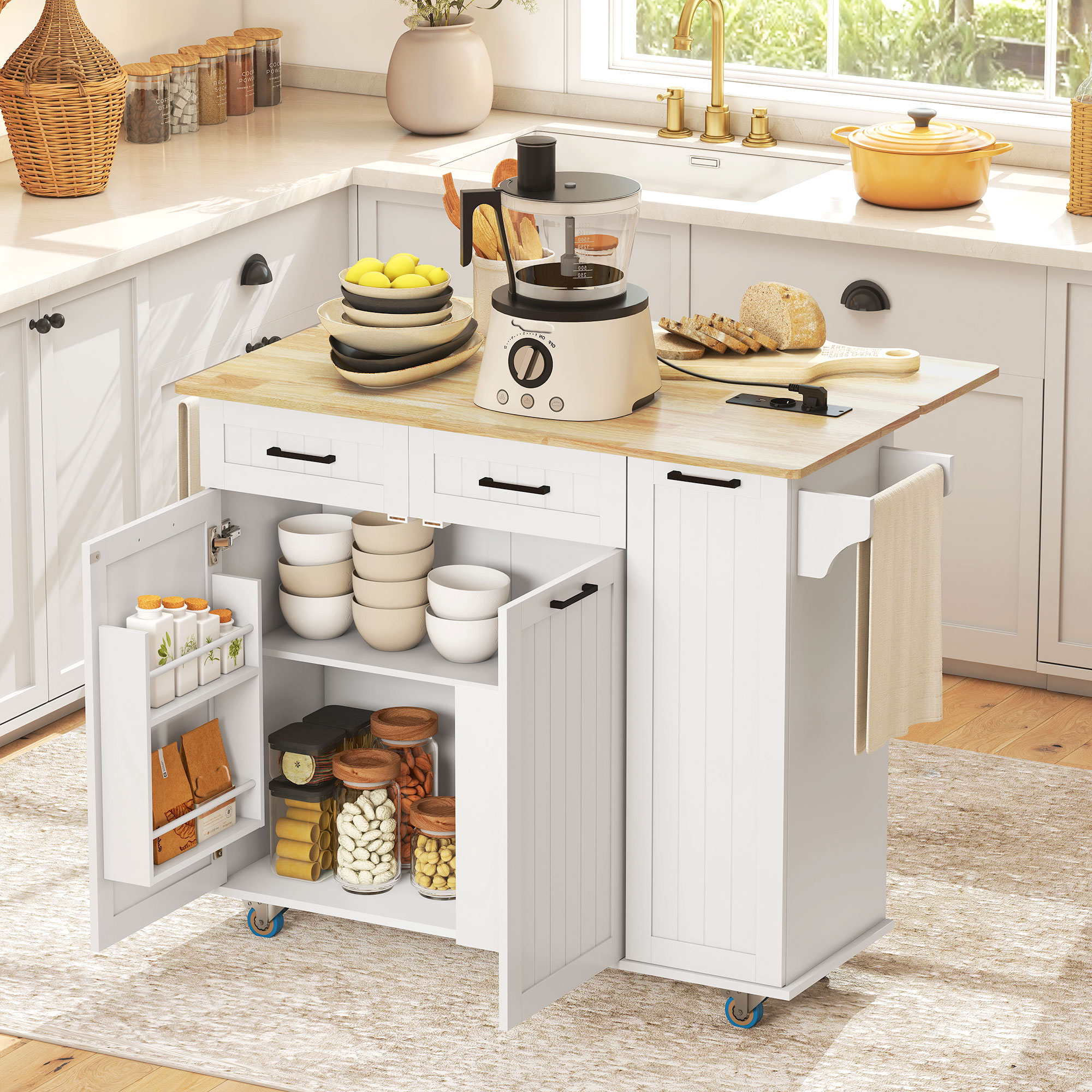 Isla de cocina blanca con puertas de armario abiertas, vajilla, comida y electrodomésticos.