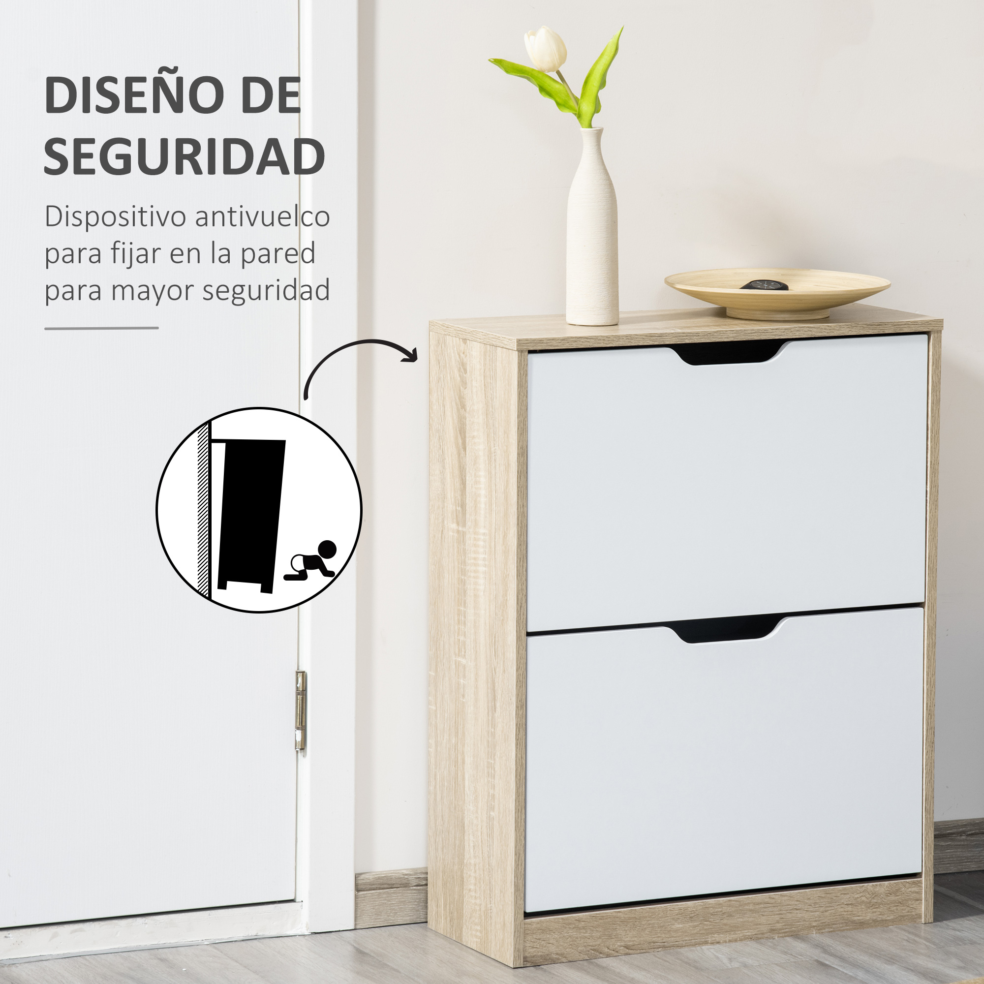 Un zapatero blanco de dos cajones está junto a una puerta. Encima hay un jarrón con una flor.