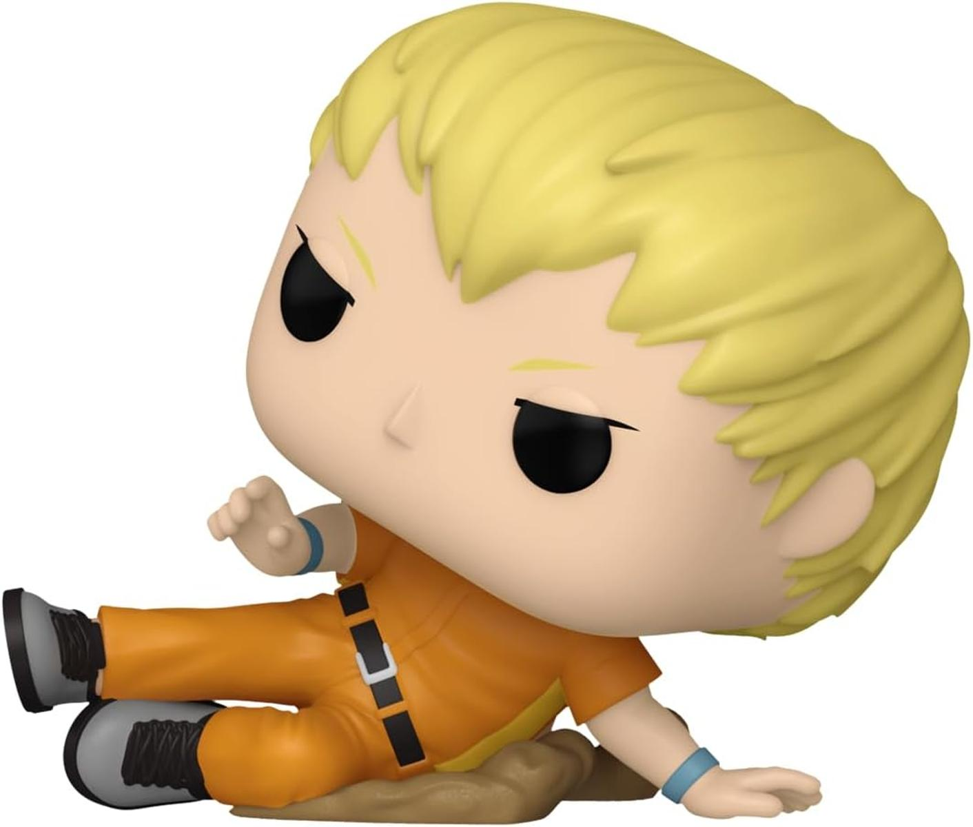 Una figura de vinilo rubia con traje naranja yace en el suelo.